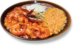 Shrimp and chicken with rice and garnishes on a black plate