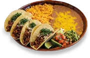 Plate of four beef tacos with lettuce, cheese, and salsa, served with yellow rice and black beans.