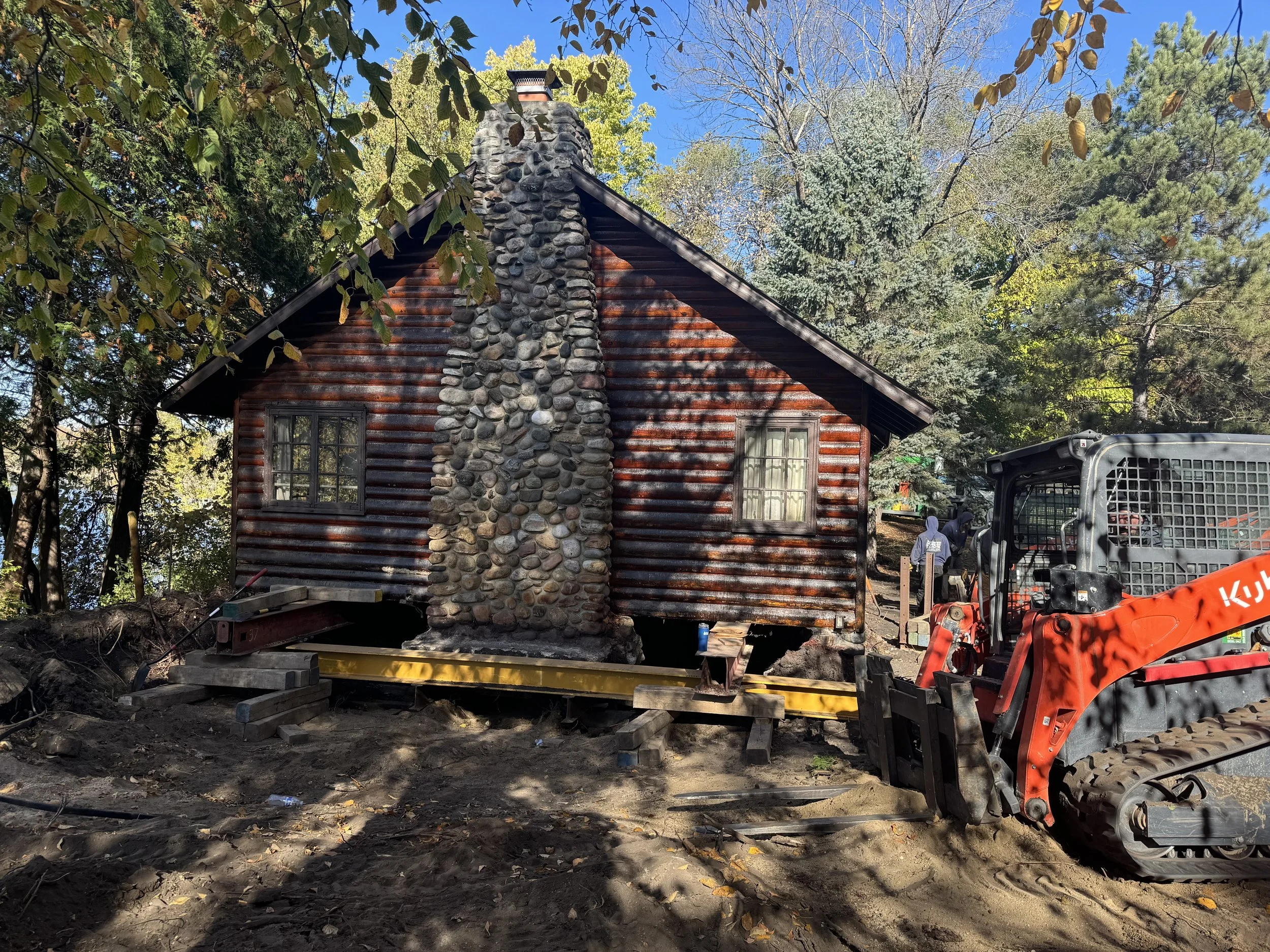 Historic log cabin lifted for relocation