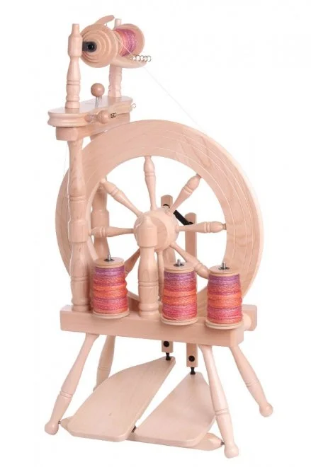 Wooden spinning wheel with colorful yarn spools