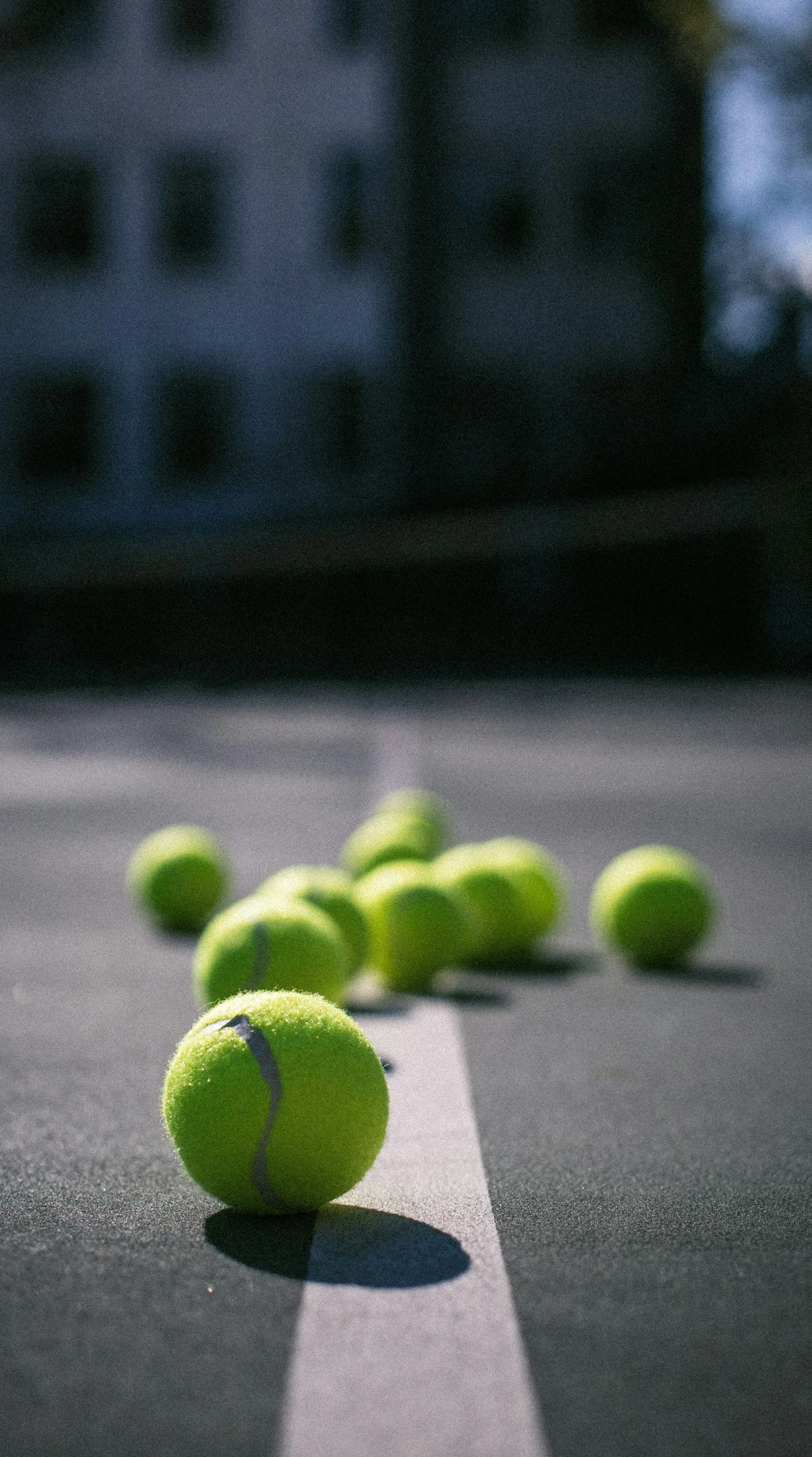close up of tennis balls on a court