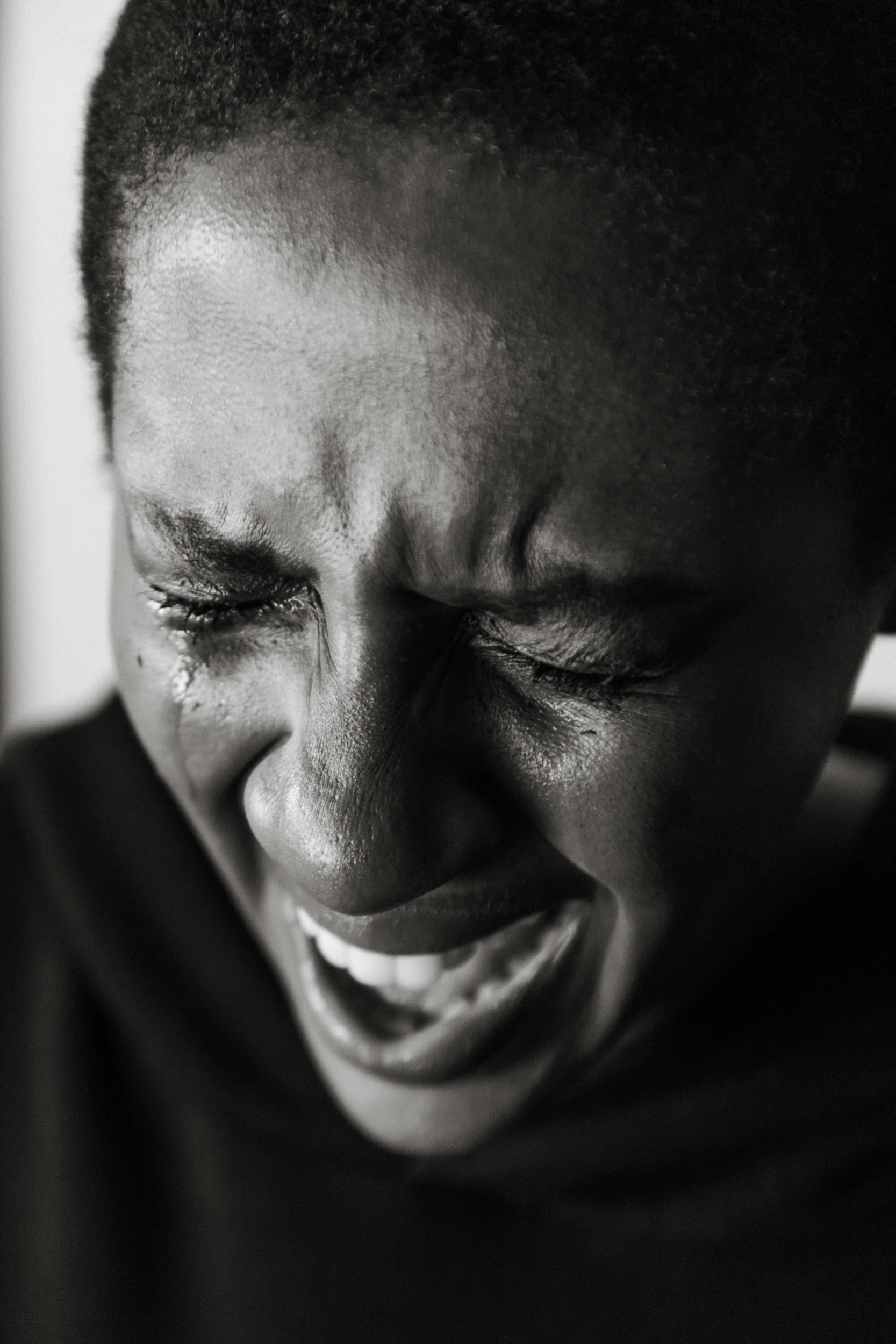 Black woman sitting alone and expressing sadness