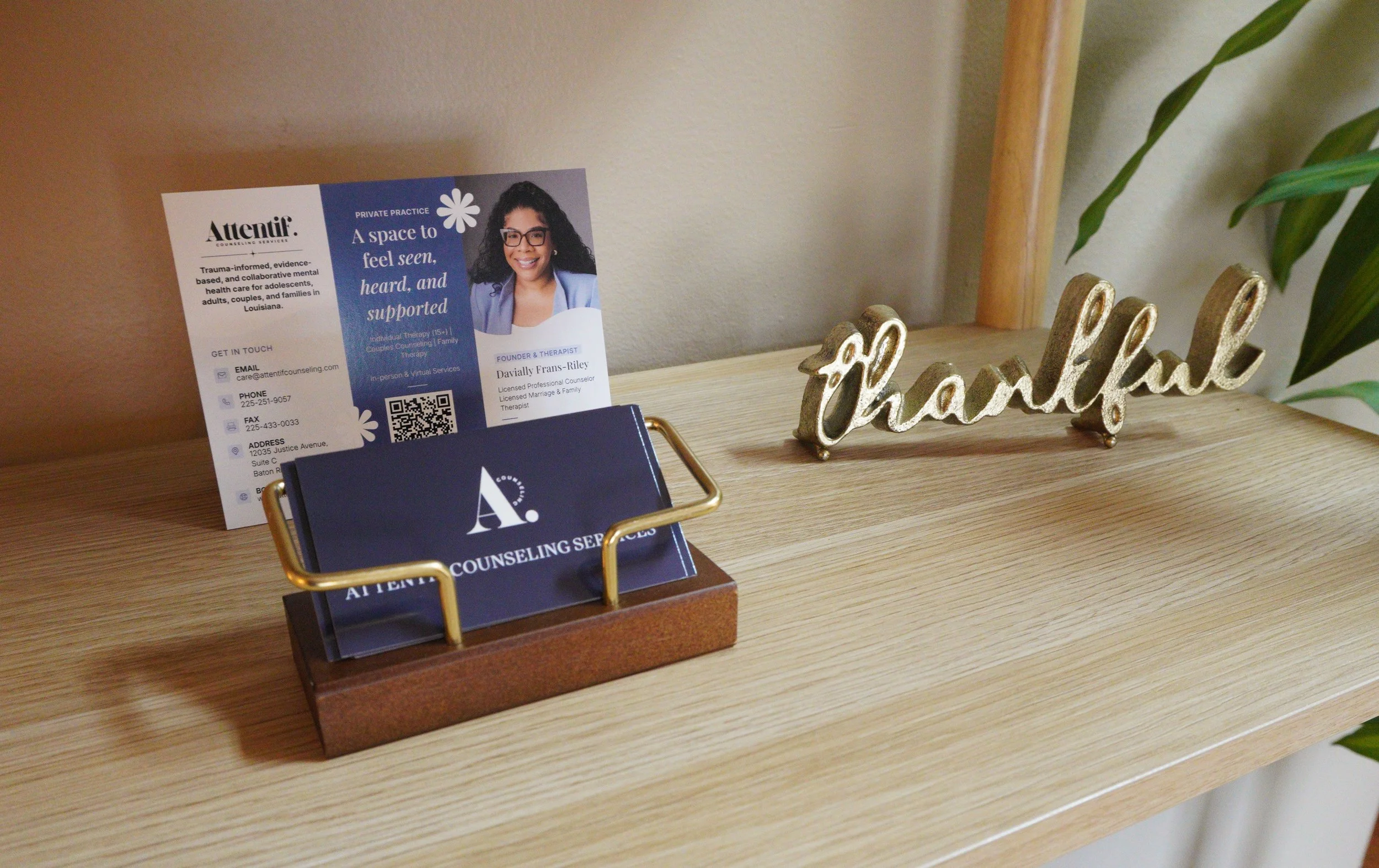 Attentif Counseling brochures and business cards beside gold thankful decor
