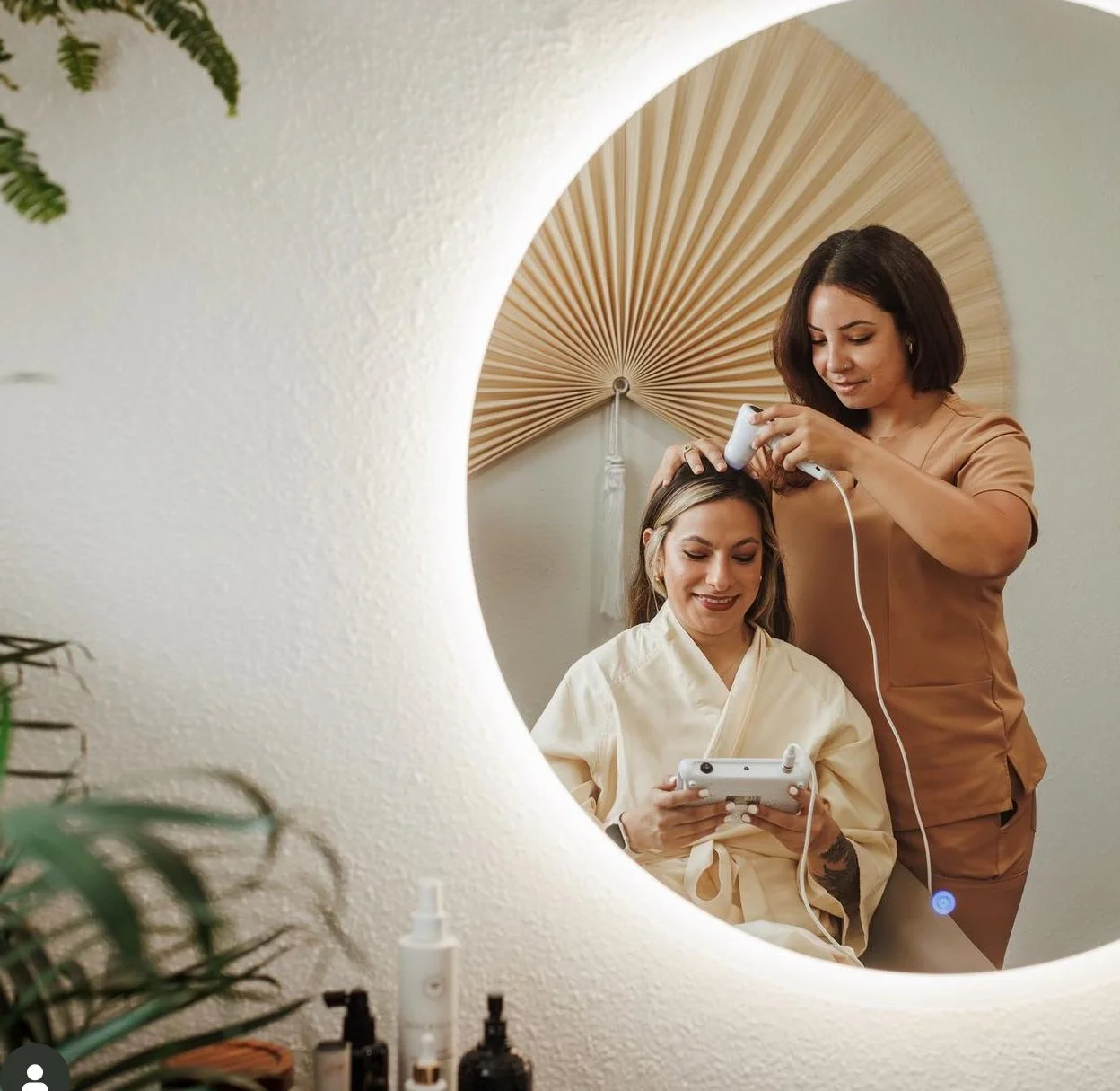 A woman getting a scalp treatment from a technician in a spa. Head spa and micrsocope training for the scalp