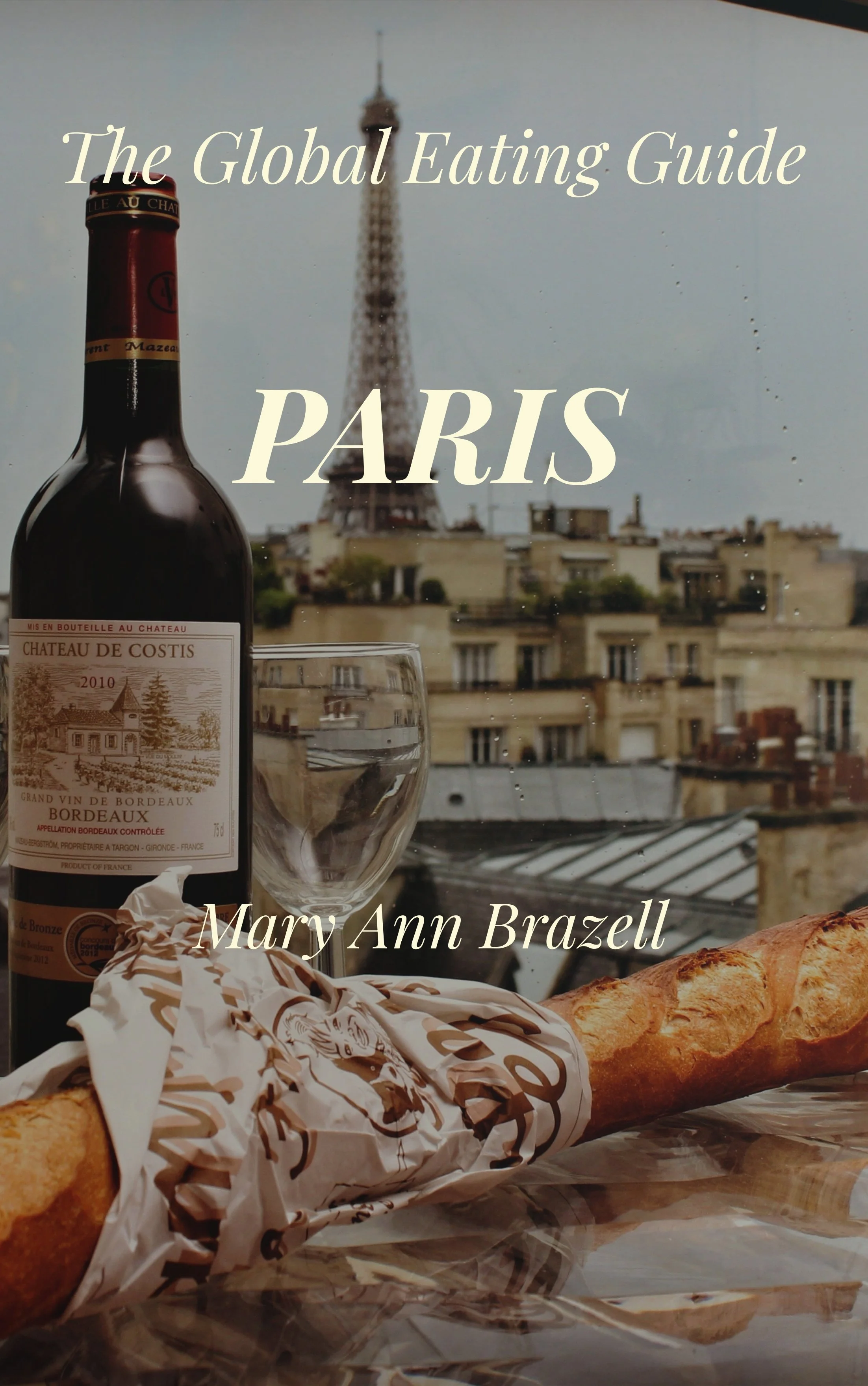 Book cover titled "The Global Eating Guide PARIS" by Mary Ann Brazell. The cover shows a Parisian cityscape with the Eiffel Tower in the background, a bottle of Bordeaux wine, a glass, a baguette, and a wrapped sandwich on a table.