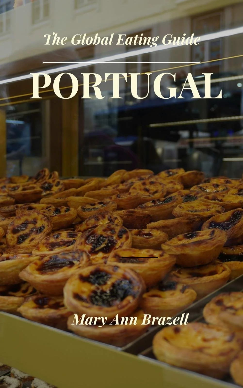 Display of Portuguese pastries called pastel de nata, also known as Portuguese custard tarts, with the title "The Global Eating Guide: Portugal" and author Mary Ann Brazell printed on the glass window.