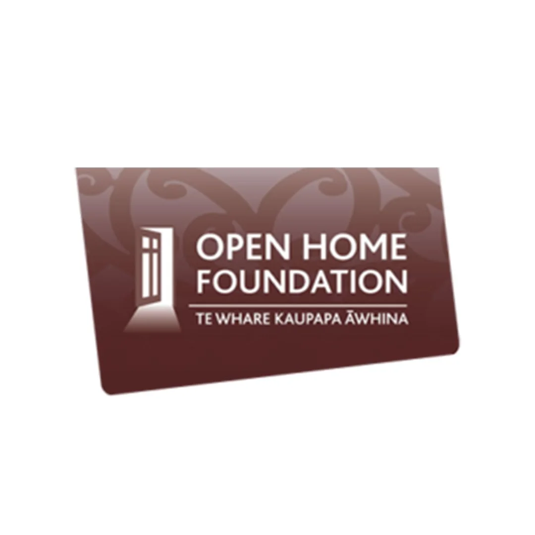 A brown promotional card for the Open Home Foundation, featuring a logo with a door and window design, and text in English and Māori.