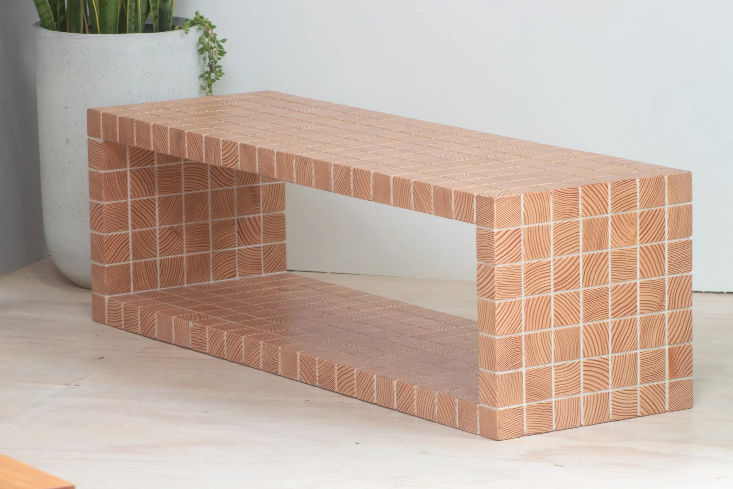 Reclaimed wood furniture constructed out of end-grain tiles.