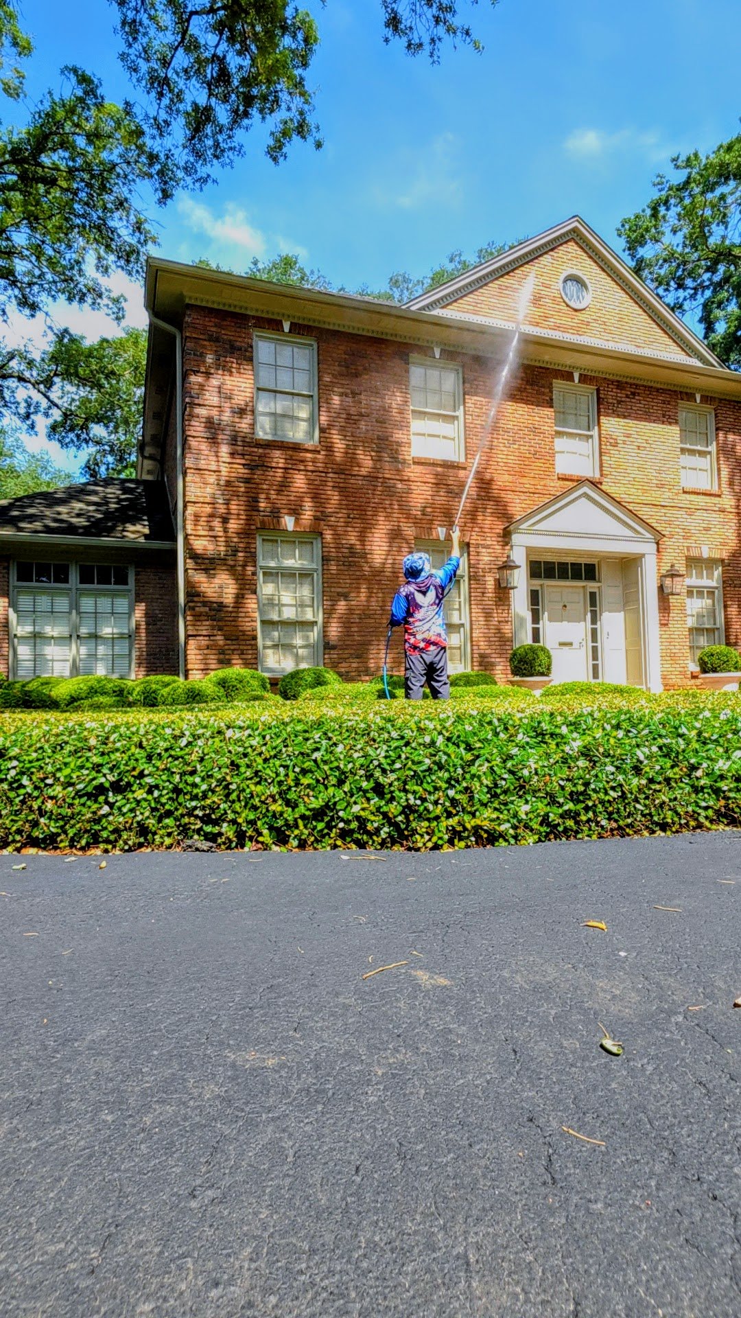Professional soft-wash service by JustaDadLegacy Power Washing on a brick home with clean exterior landscaping in Pensacola