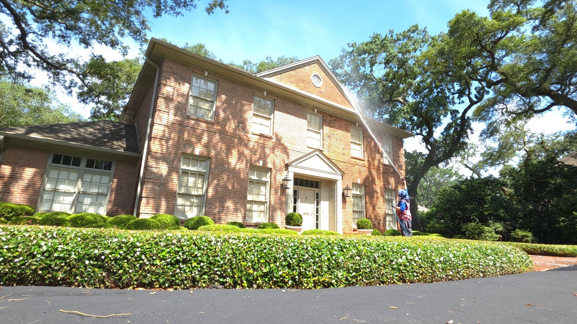 Beautifully cleaned brick home and driveway following professional pressure washing services by JustaDadLegacy Power Washing