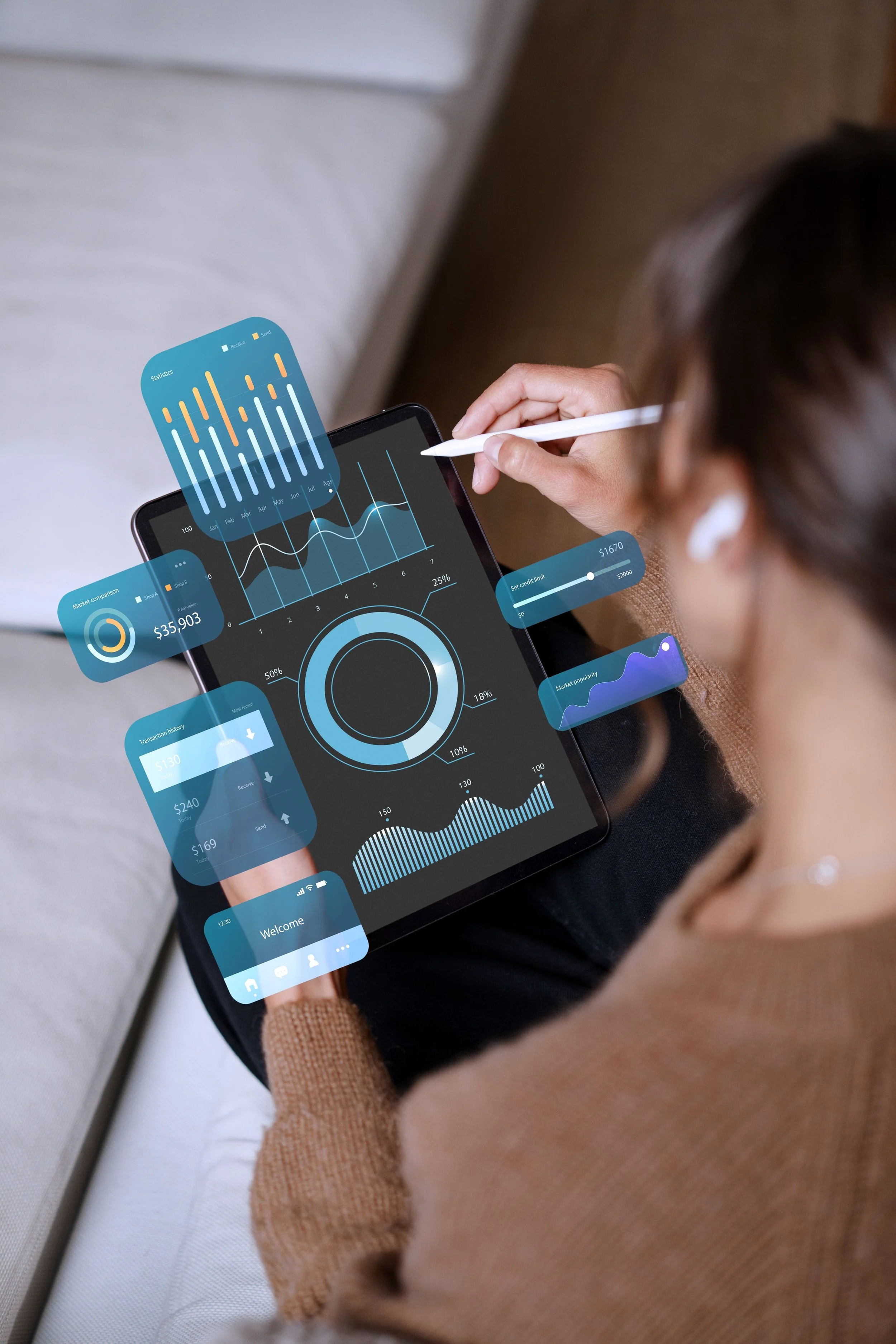 A person holding a tablet displays financial and statistical data charts and graphs, with digital overlay interface showing various financial metrics and activity.