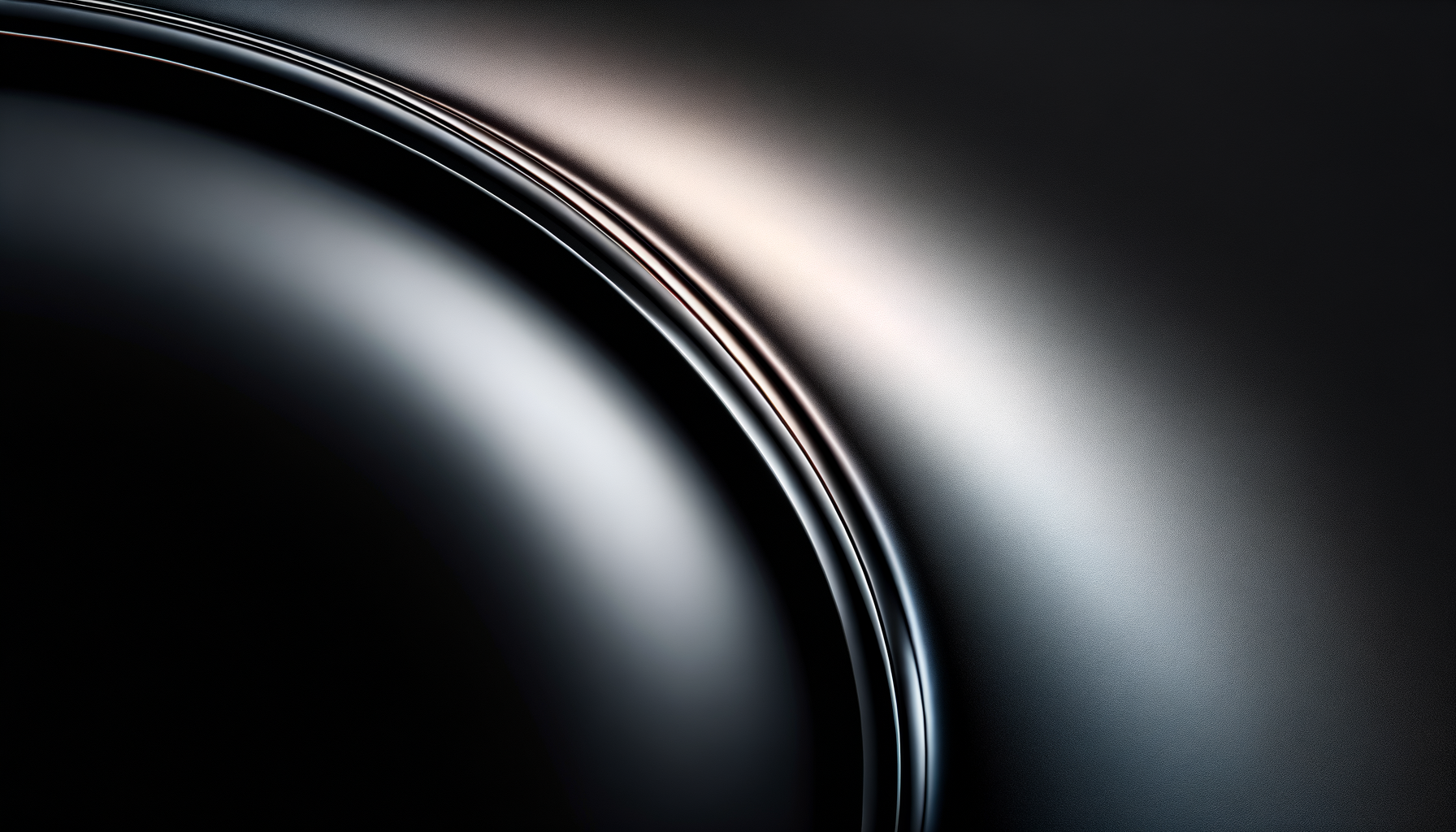 Close-up of a sleek, modern metallic object with smooth curves and shiny highlights, possibly part of a luxury device or machinery.