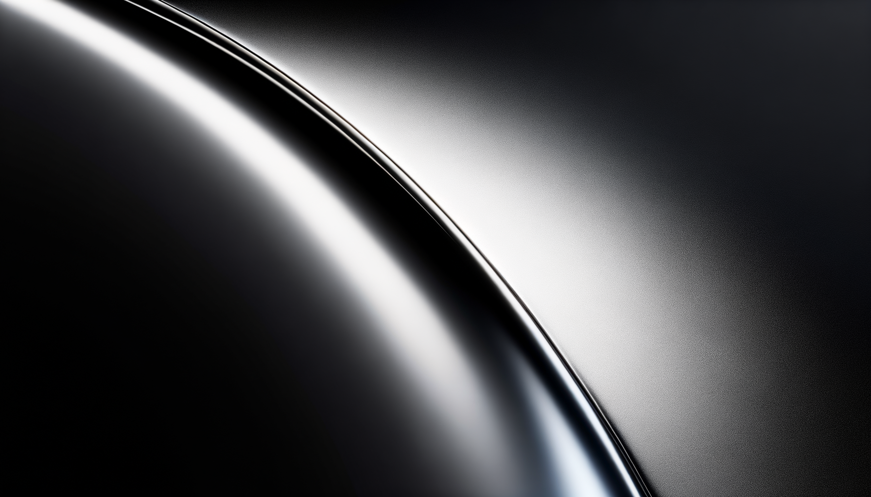 Close-up of a sleek, curved metallic surface with a light reflection creating a shiny highlight.