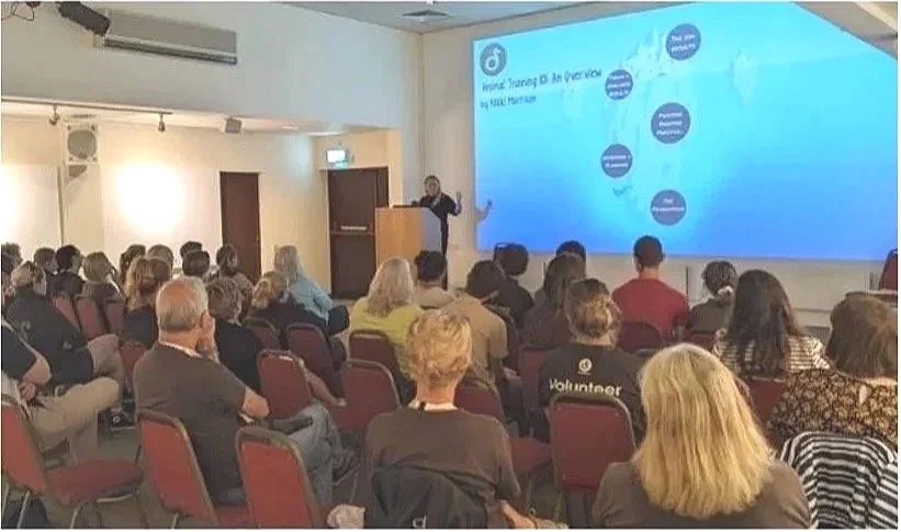 Nikki Morrison delivering an animal welfare training session to a seated professional audience.