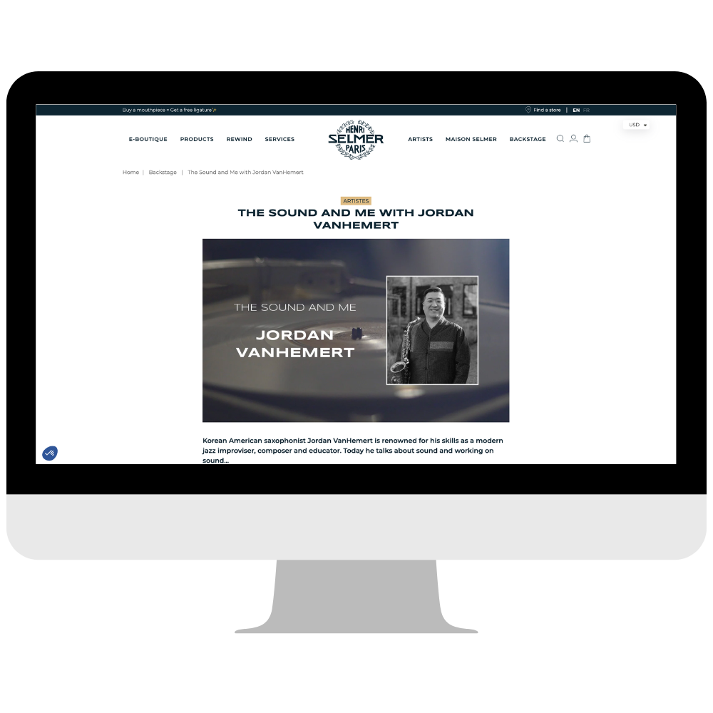 Webpage on a computer screen featuring an article about Jordan VanHemert, a Korean American saxophonist, with a black and white photo of him holding a saxophone and text about his musical work.