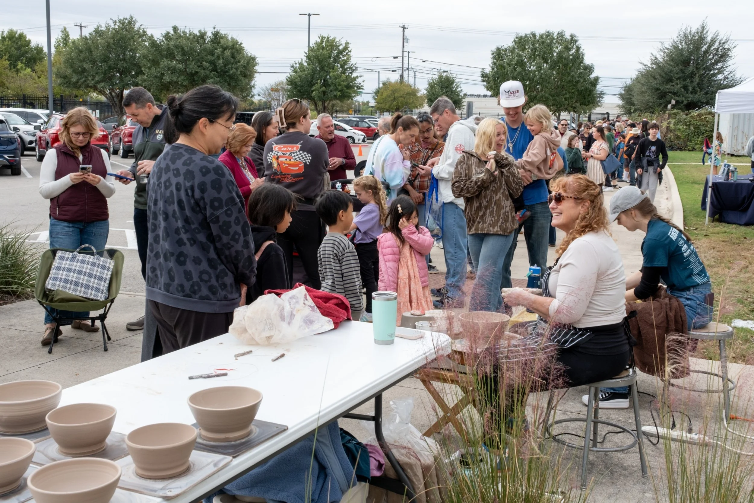 Potters on wheel and crowd.jpg