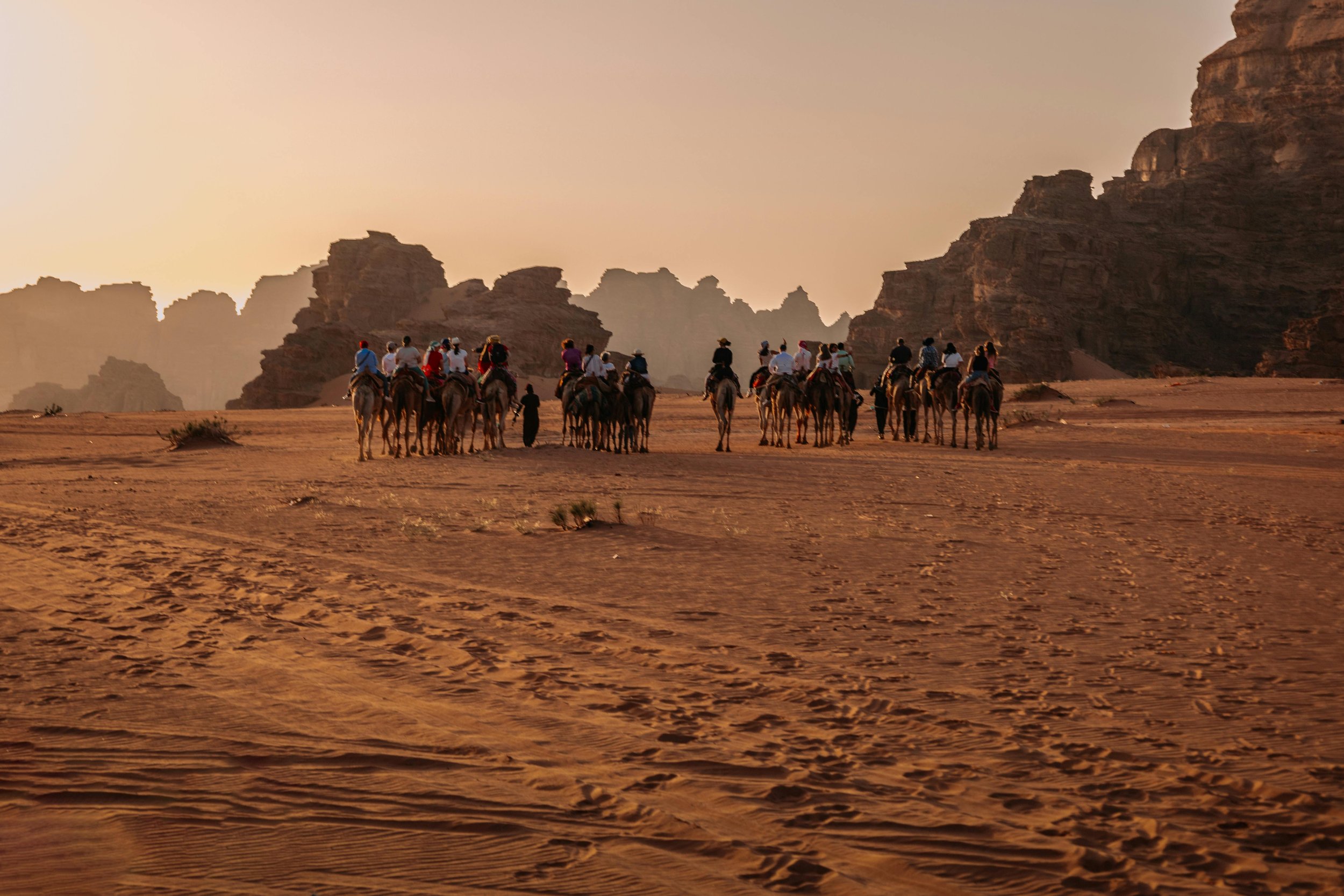 Experience Jordan through Wadi Rum's desert landscape with large rock formations and red sand dunes.