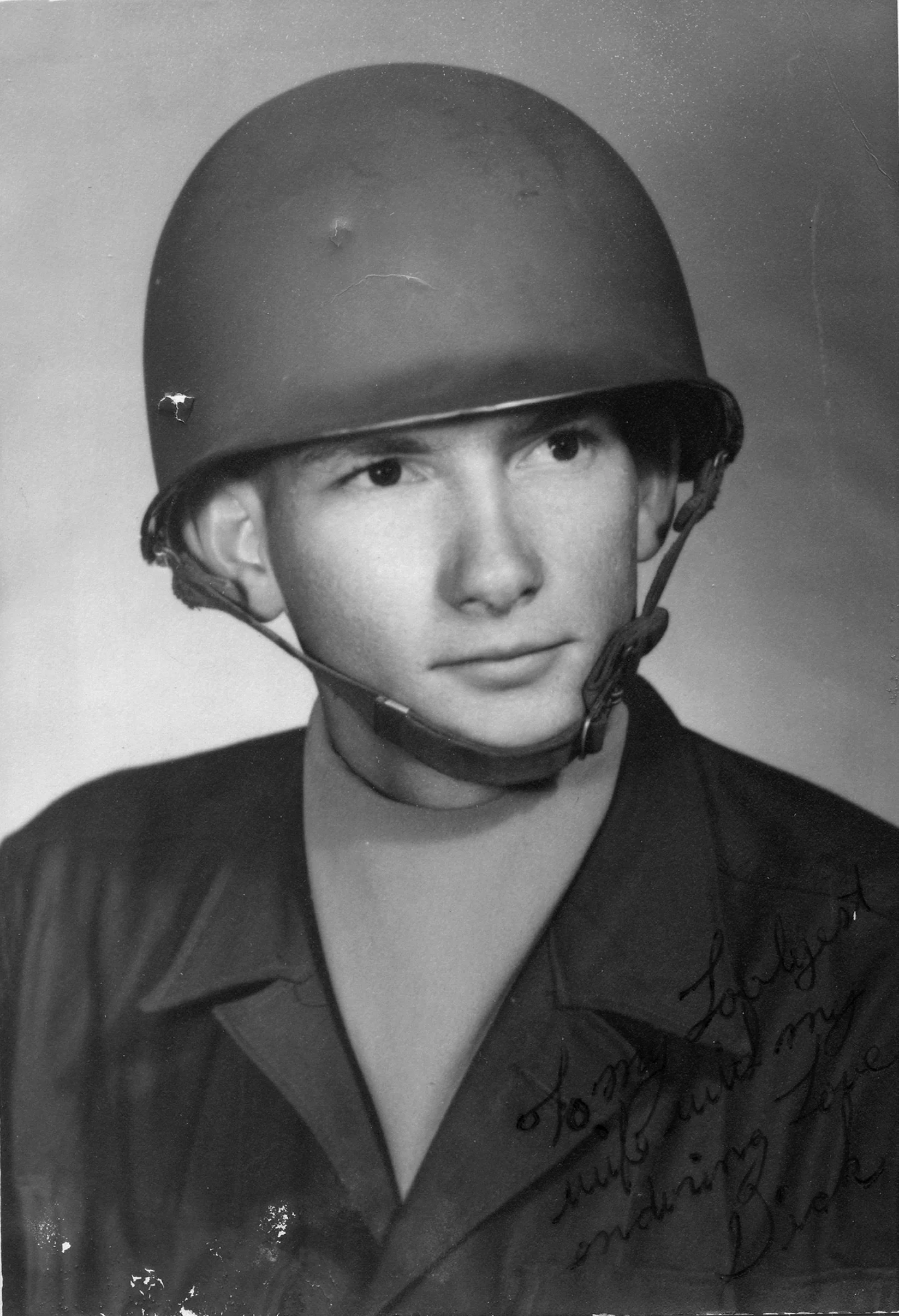 Black and white photo of a young person wearing a helmet and a jacket, with handwritten text on the bottom right corner. My Dad, Richard Sumner