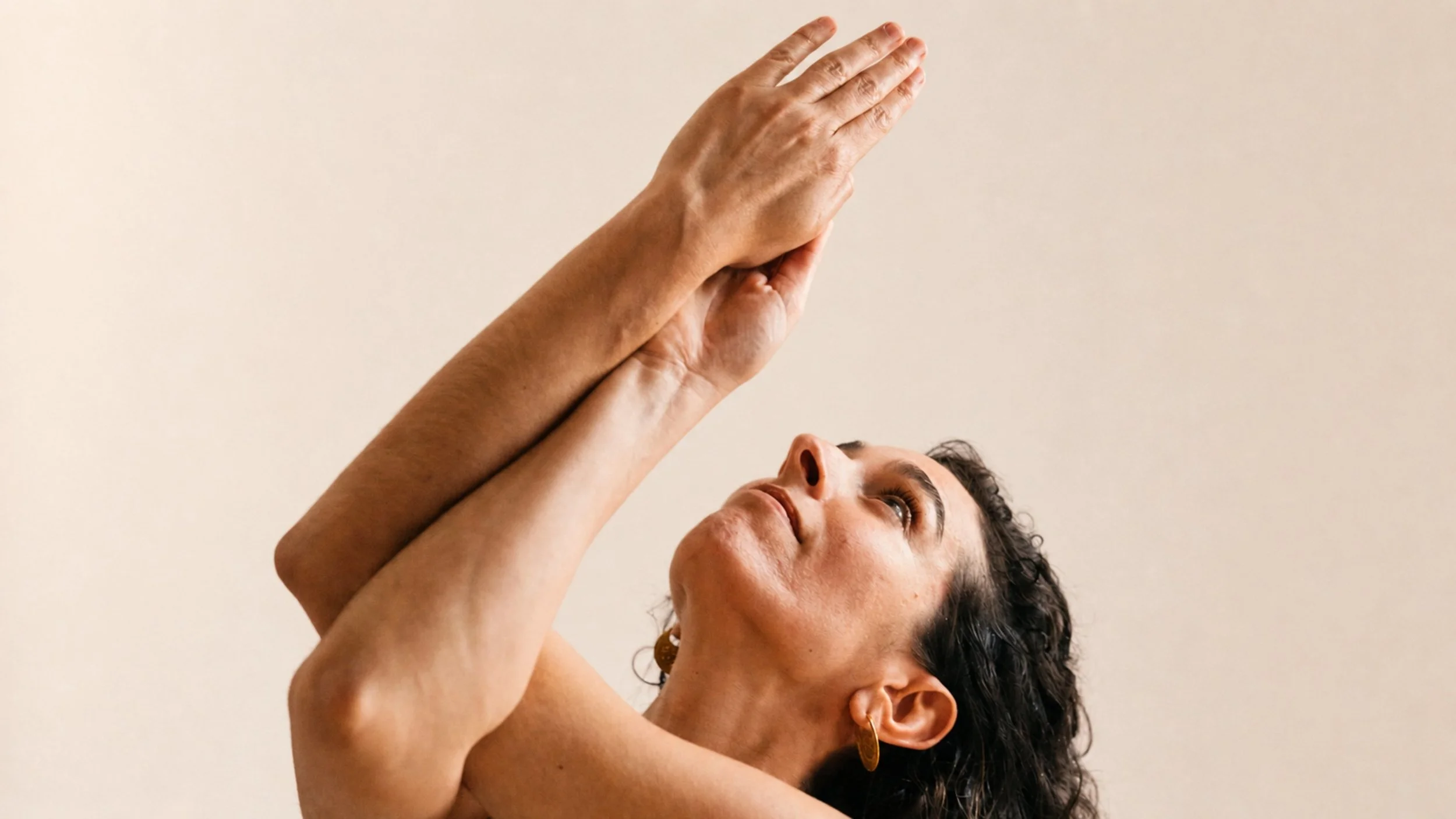 a woman intertwines her hands as she looks up