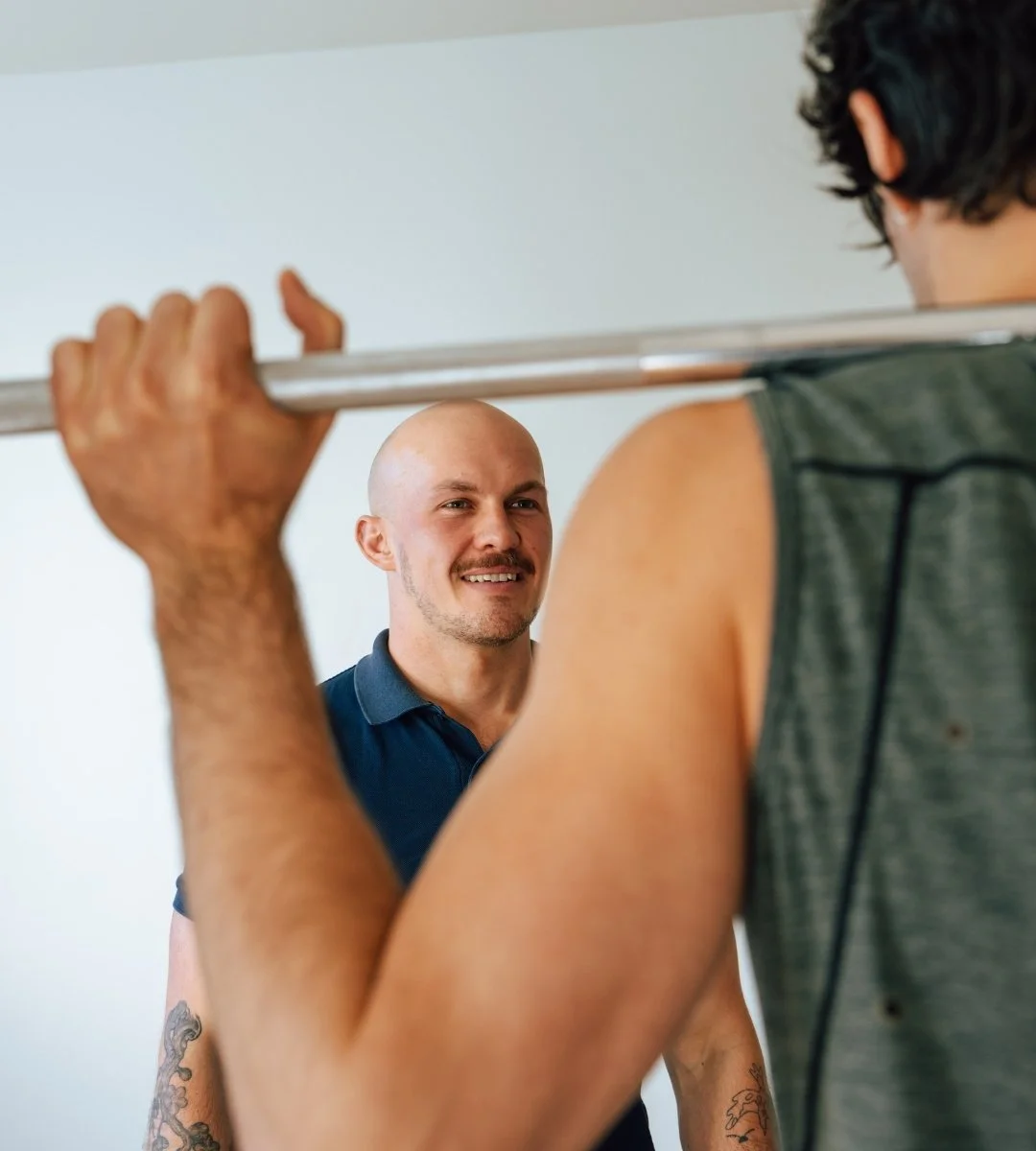 A personal trainer coaches a client