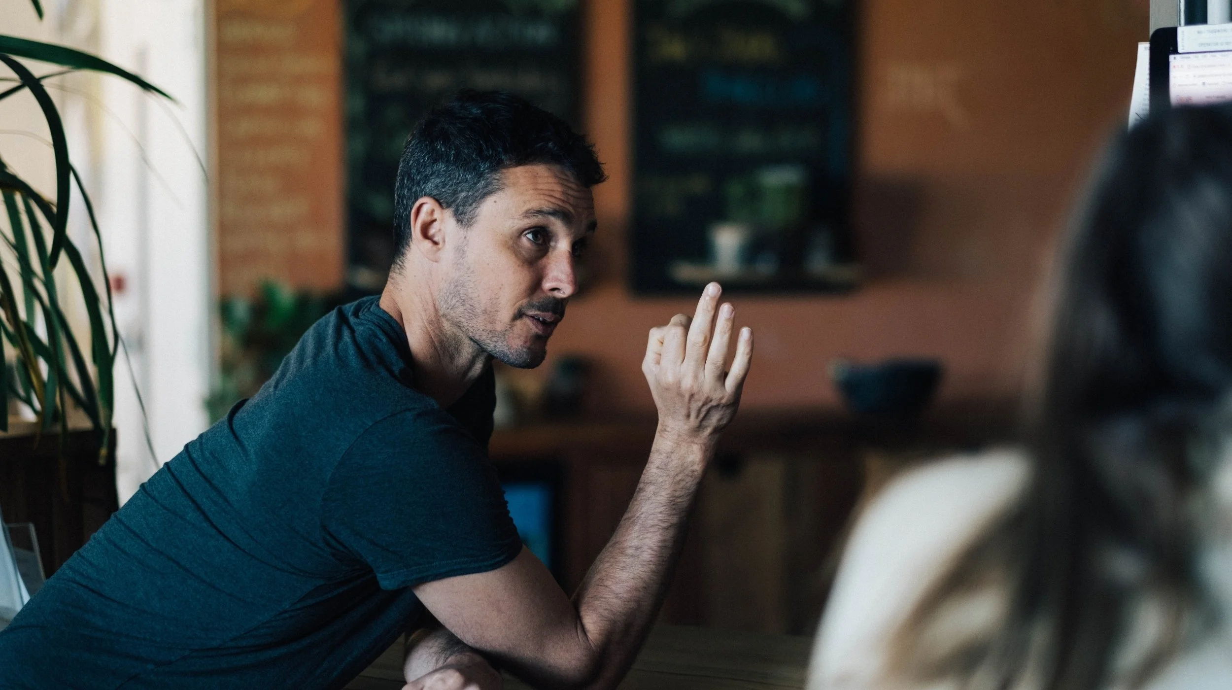 a man talks in a yoga studio