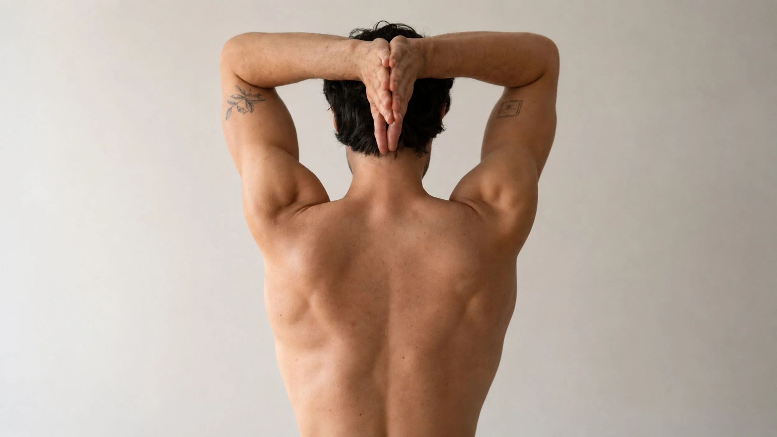 A man holds his hands together behind his back