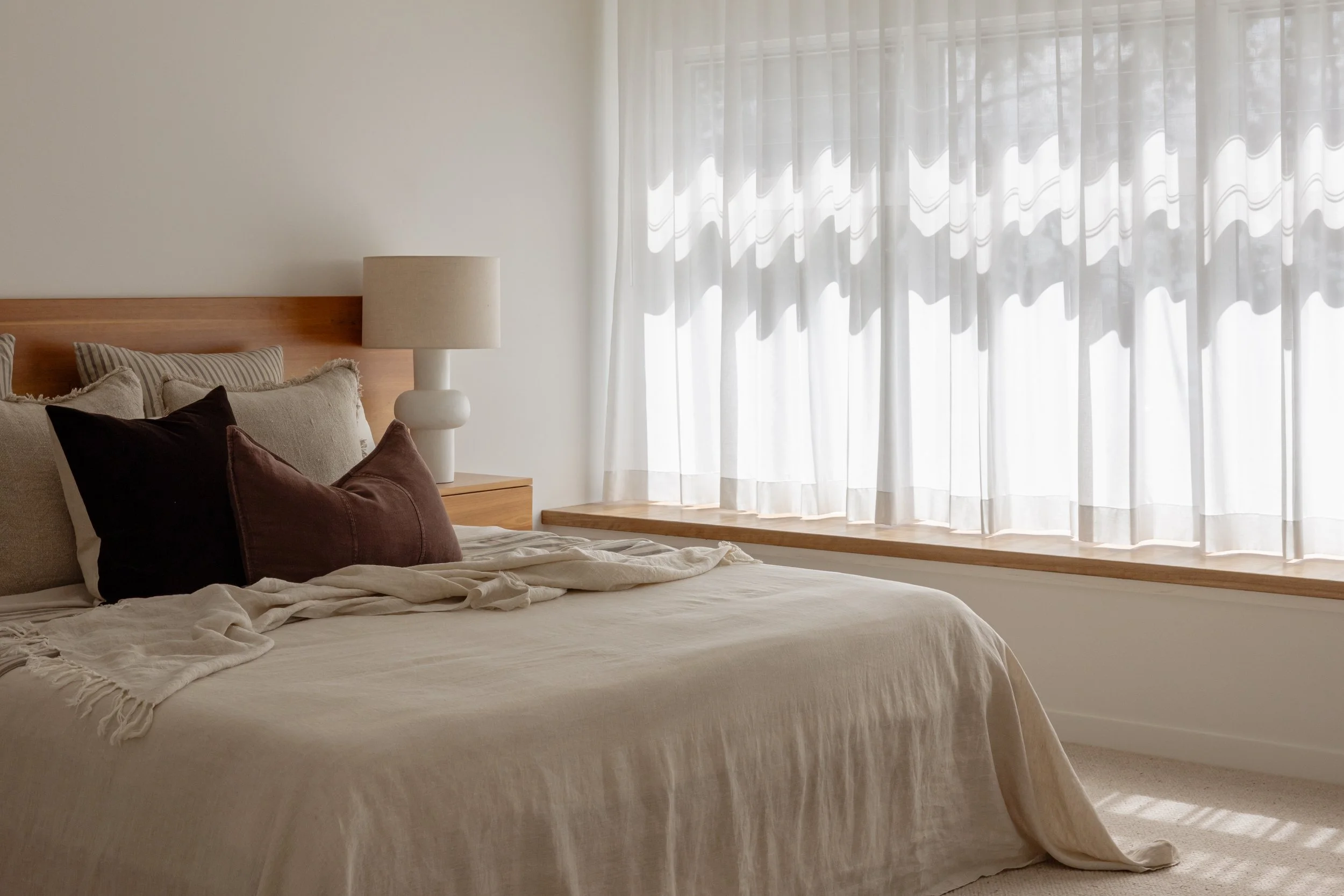 Renovated bedroom with sheer curtains