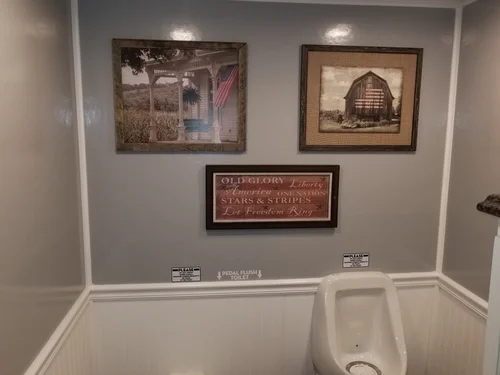 Men's room with art and urinal