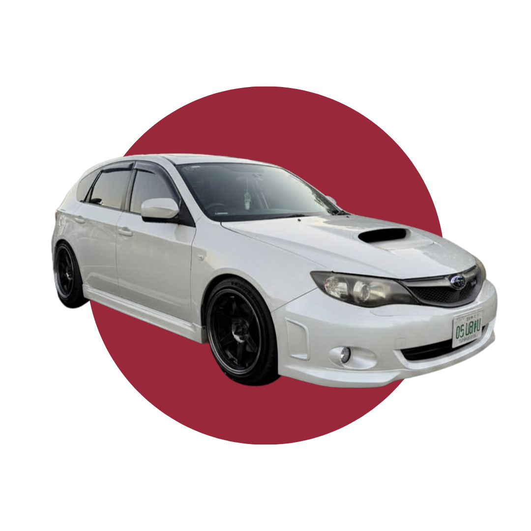 White Subaru WRX wagon with black wheels set against a red and black graphic background, reflecting Detail Culture’s Japanese-inspired car culture aesthetic.