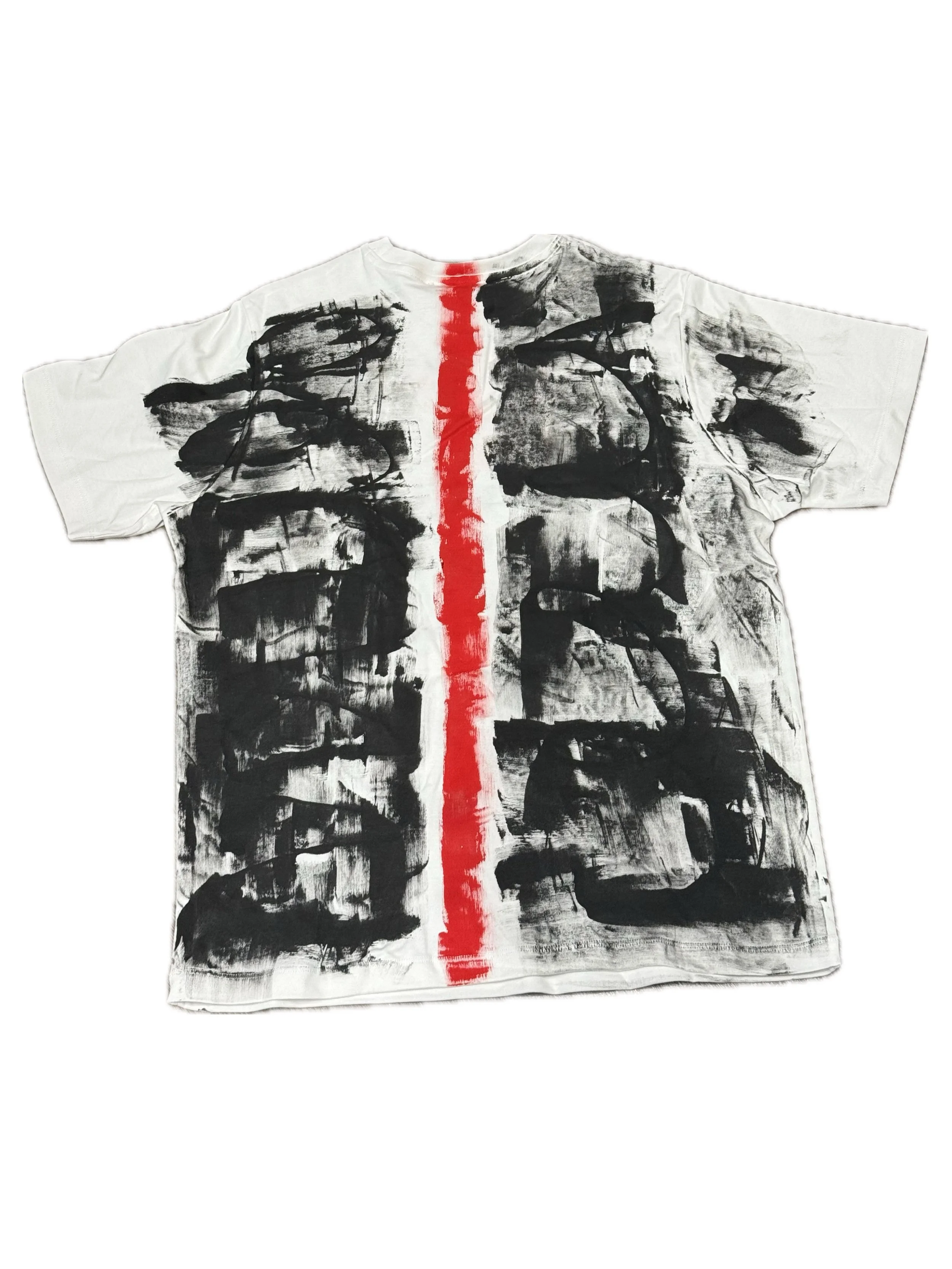 A t-shirt with black abstract brushstroke patterns and a vertical red stripe down the middle.
