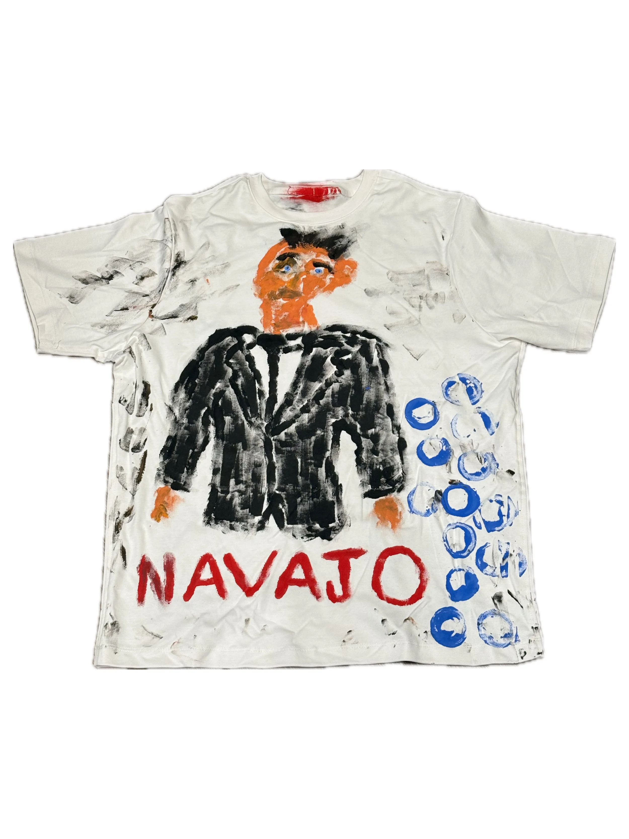 A painted T-shirt featuring a portrait of a man with dark hair and bright blue eyes, wearing a black jacket, with the word 'NAVAJ0' in red at the bottom and a series of blue circles along the right side.