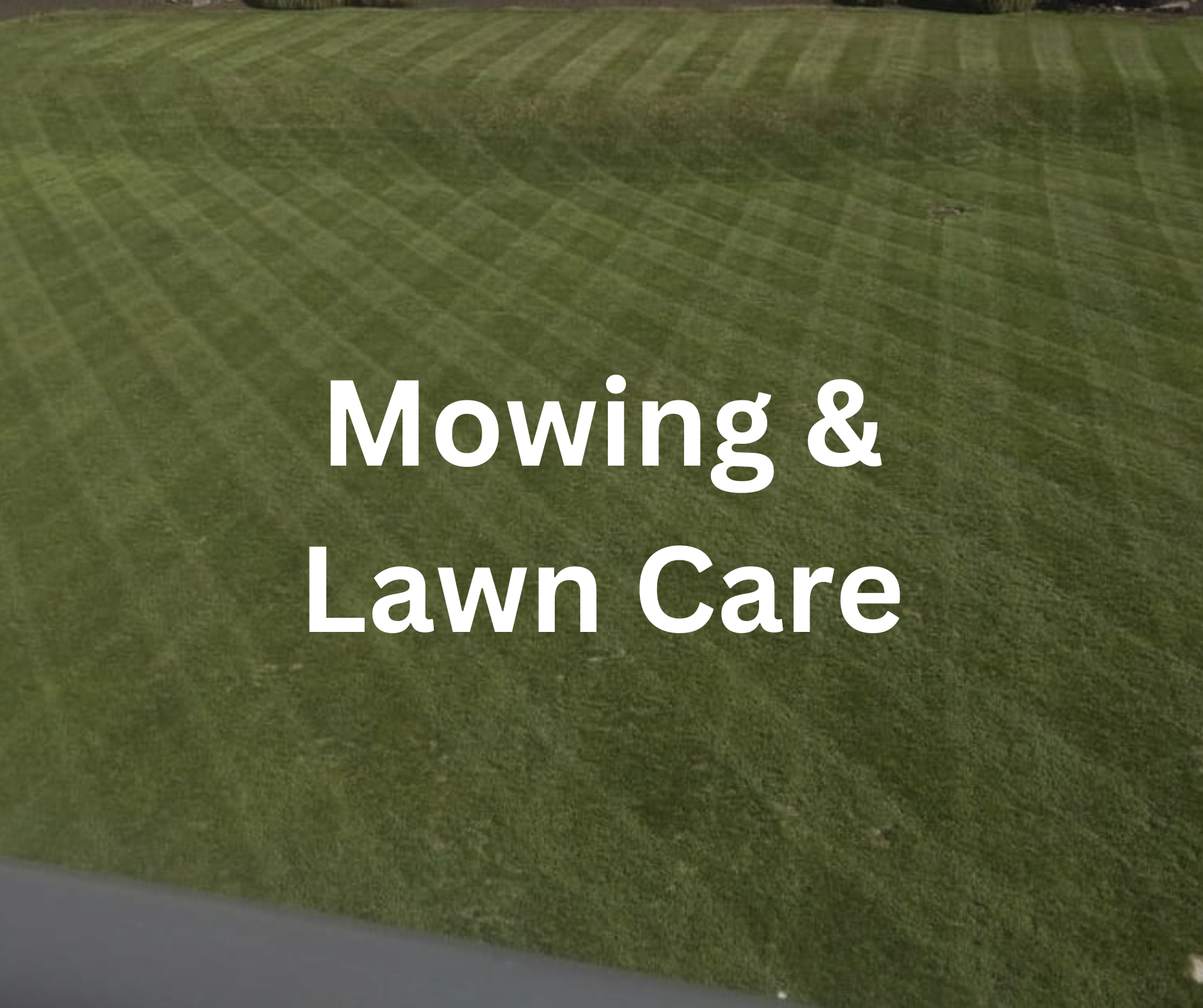 Green lawn with visible mowing lines and partial text reading 'Mowing & Lawn Care' overlaid on the grass.
