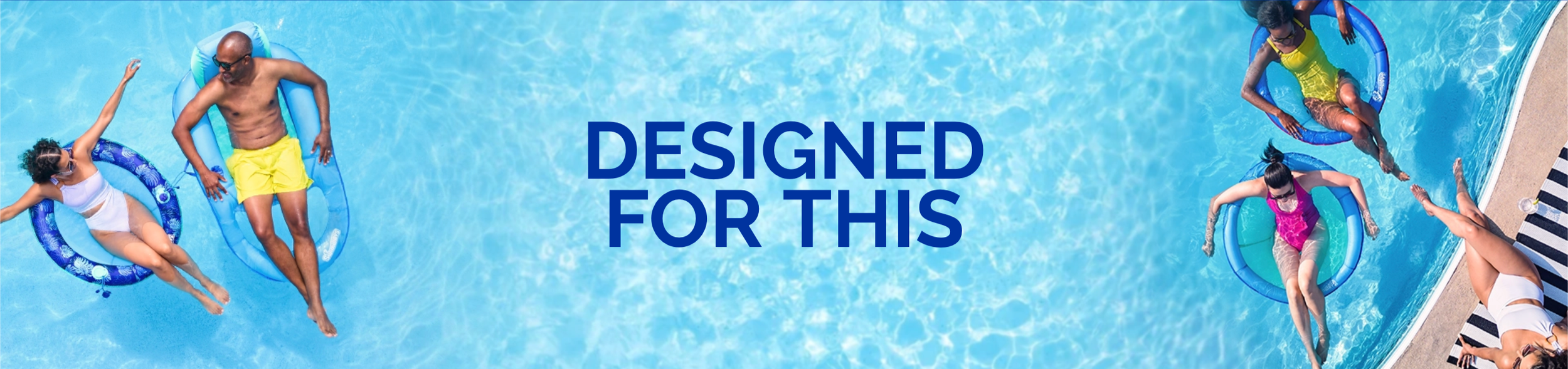People relaxing on pool floats in a swimming pool with the text 'Designed for This' in the center.