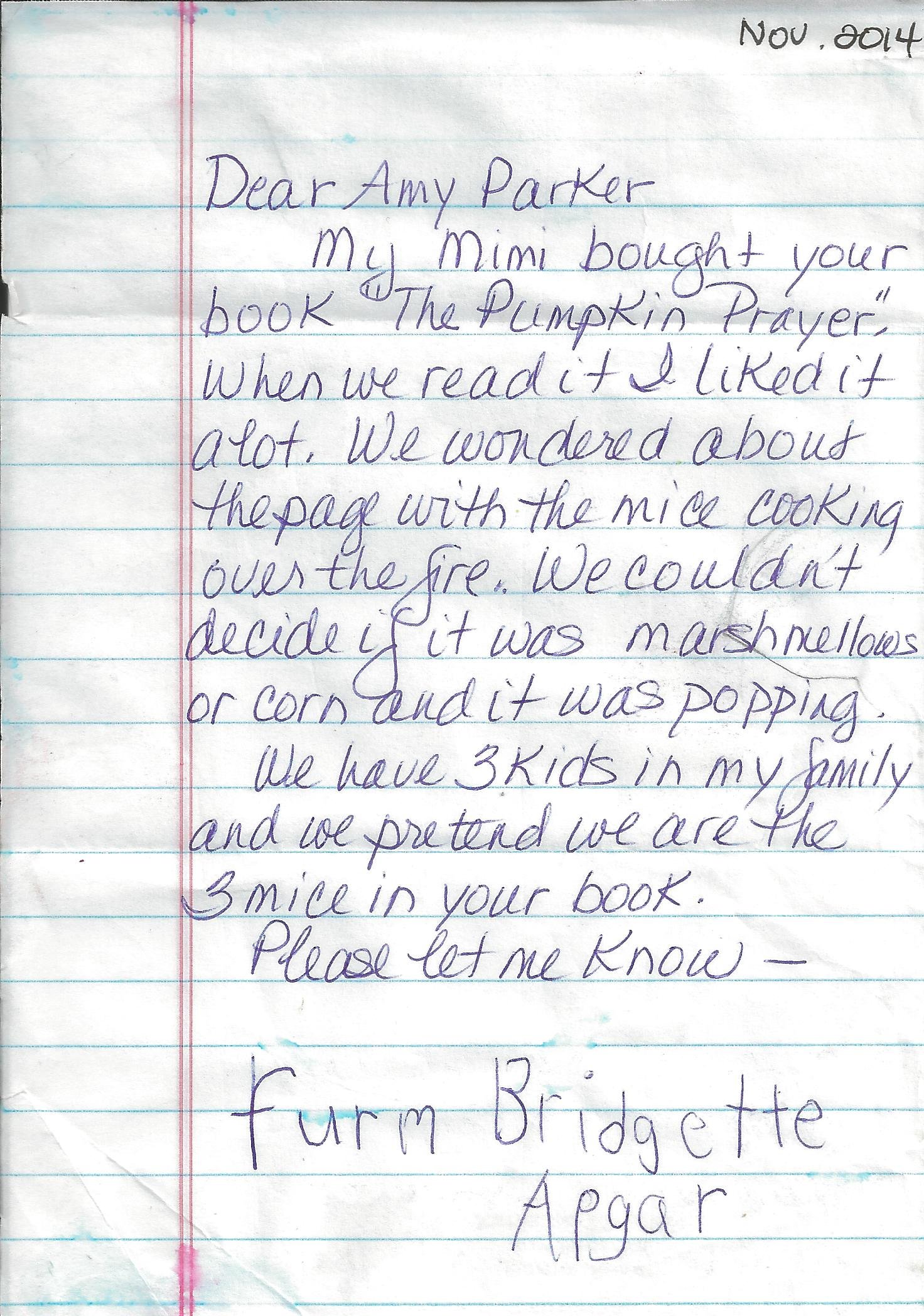 A handwritten letter on lined notebook paper, with text addressed to Amy Parker about a book called "The Pumpkin Prayer" and the activities involving a page with a melting ice/corncob or marshmallow and pasting a picture in the book. The note has a date of November 2014 in the top right corner.