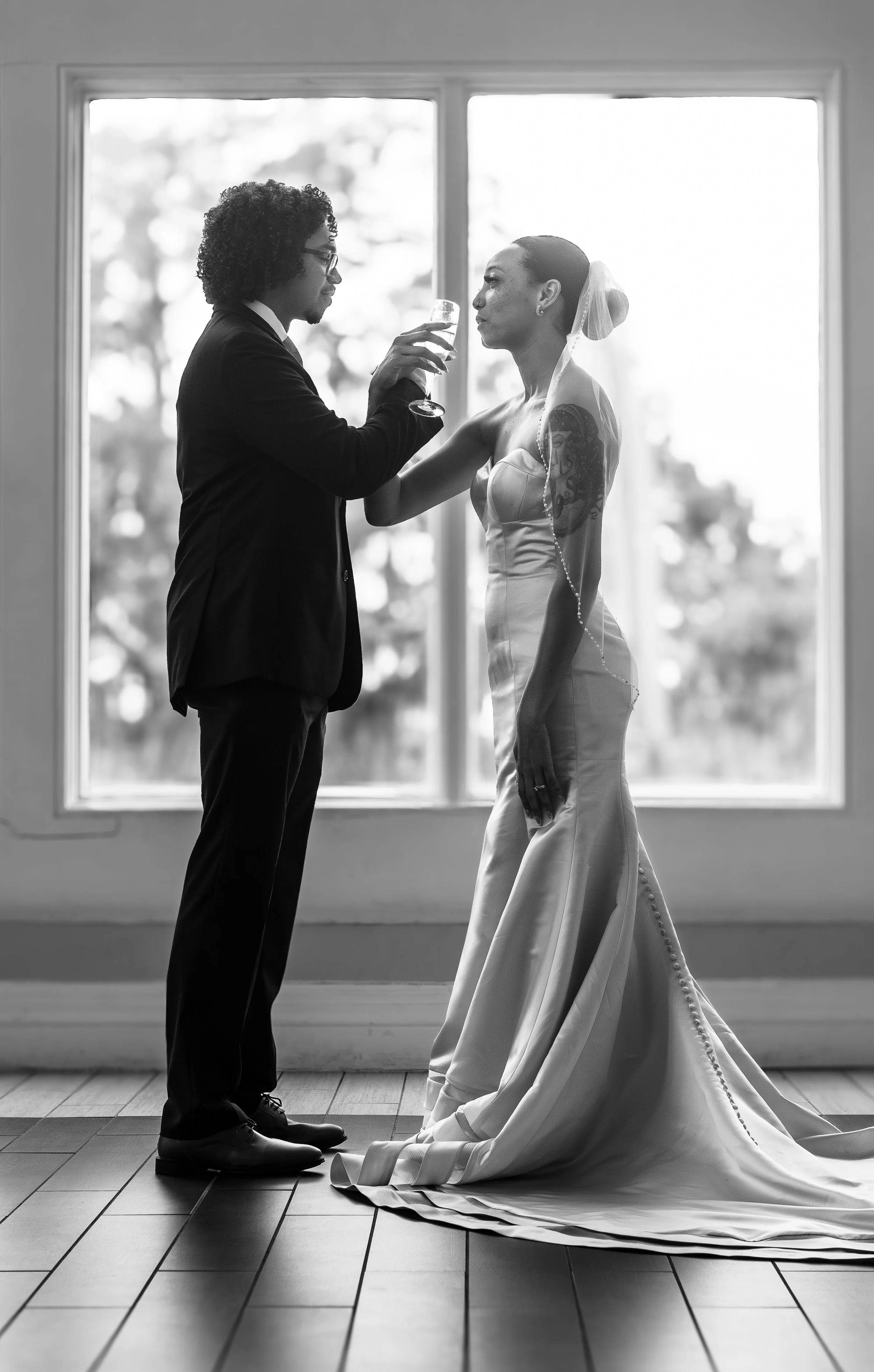 bride and groom holding drink glasses