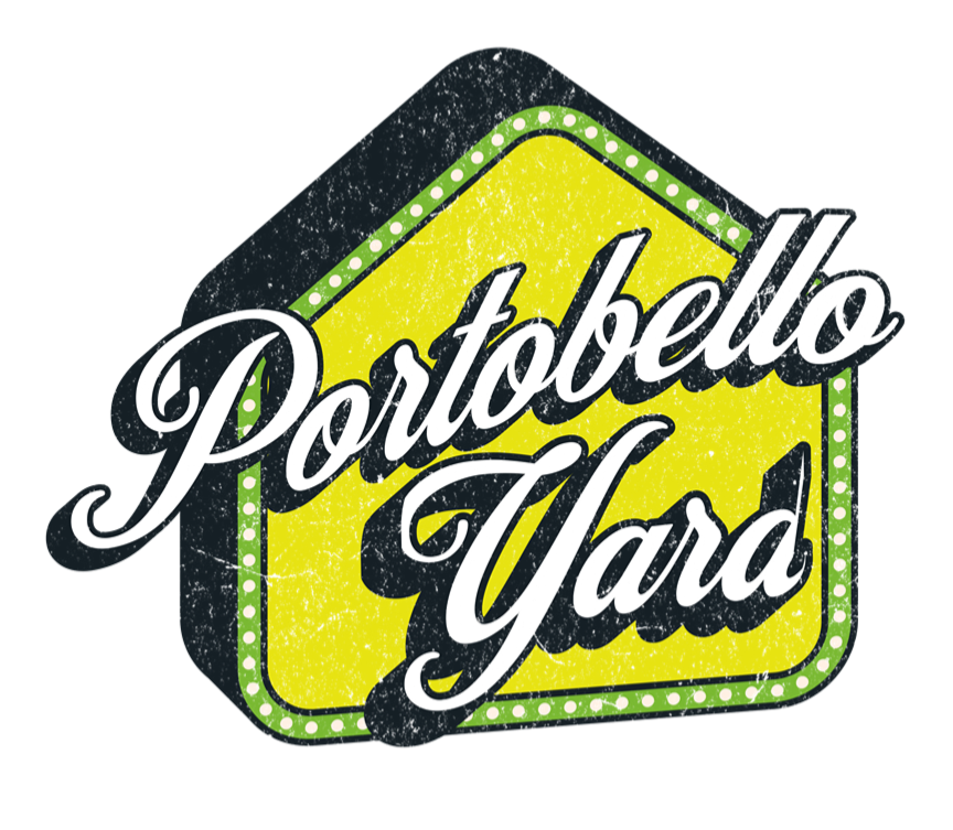 Logo for Portobello Yard featuring a yellow house shape with a dotted green border and black shadow, with white cursive text.