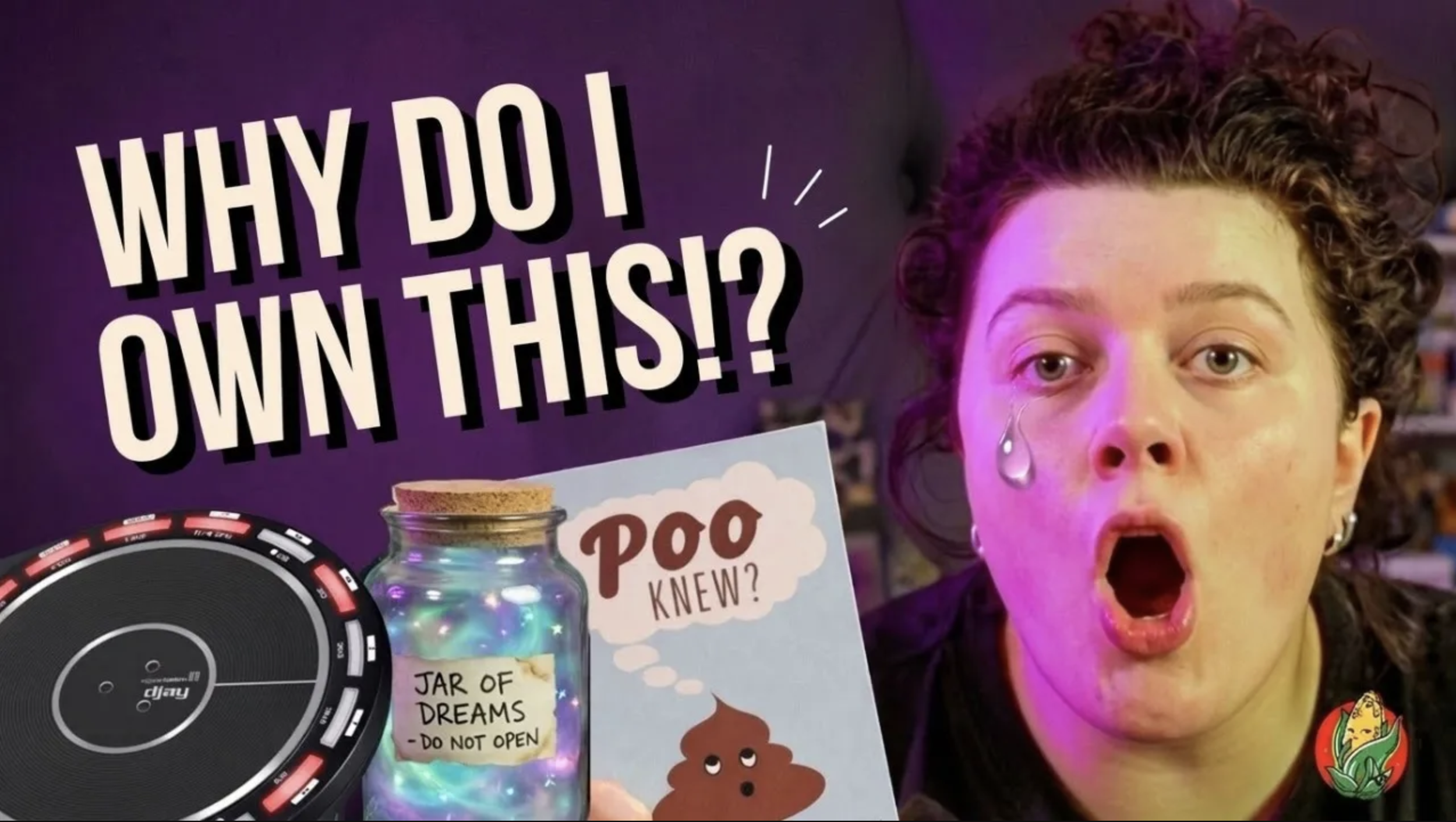 A young girl with curly hair and a surprised expression, her mouth open and tears on her face, standing behind various items including a colorful jar labeled "Jar of Dreams - Do Not Open", a game board, and a sign asking "Why Do I Own This?!"