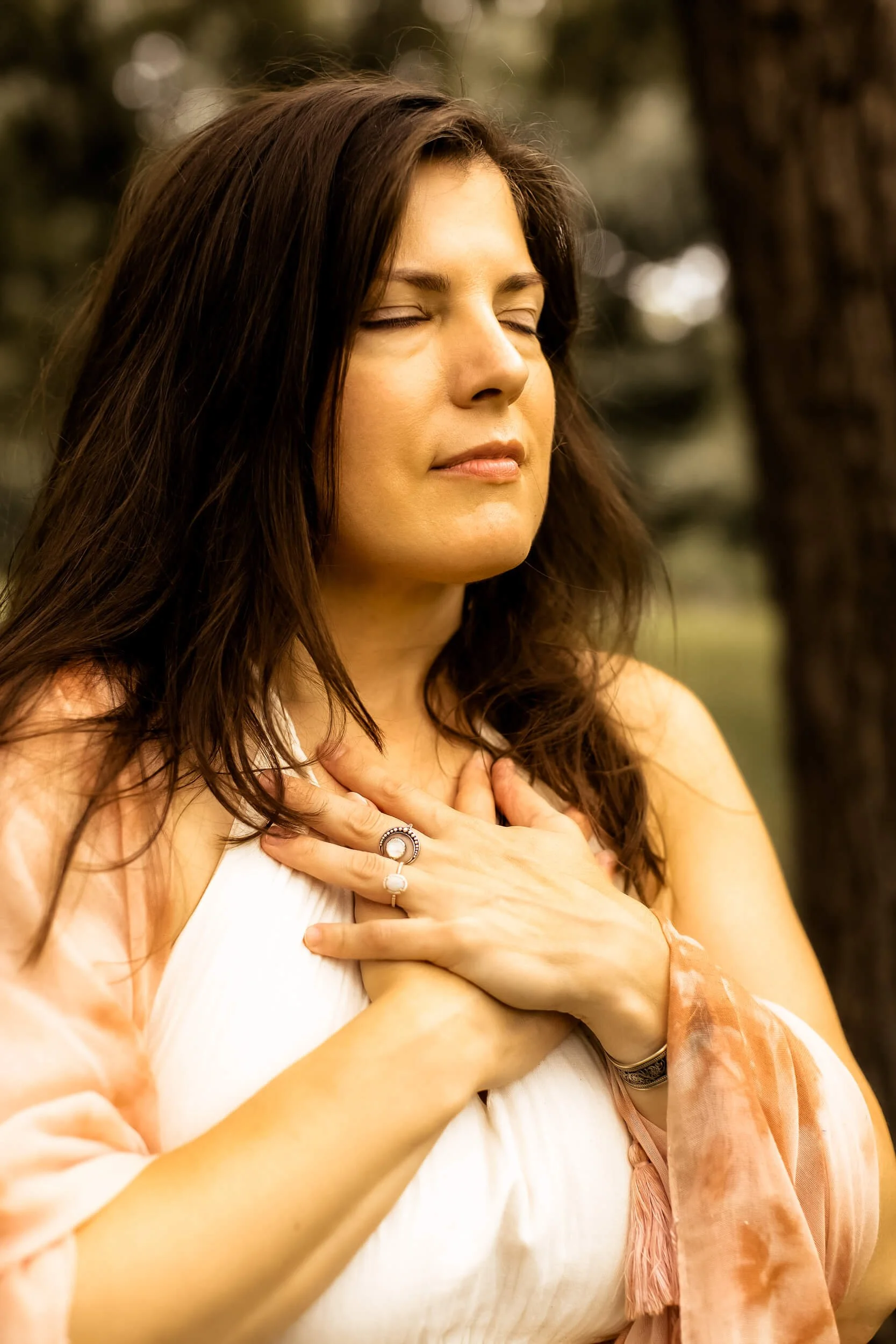 Kristi Amdahl with eyes closed and hands on heart