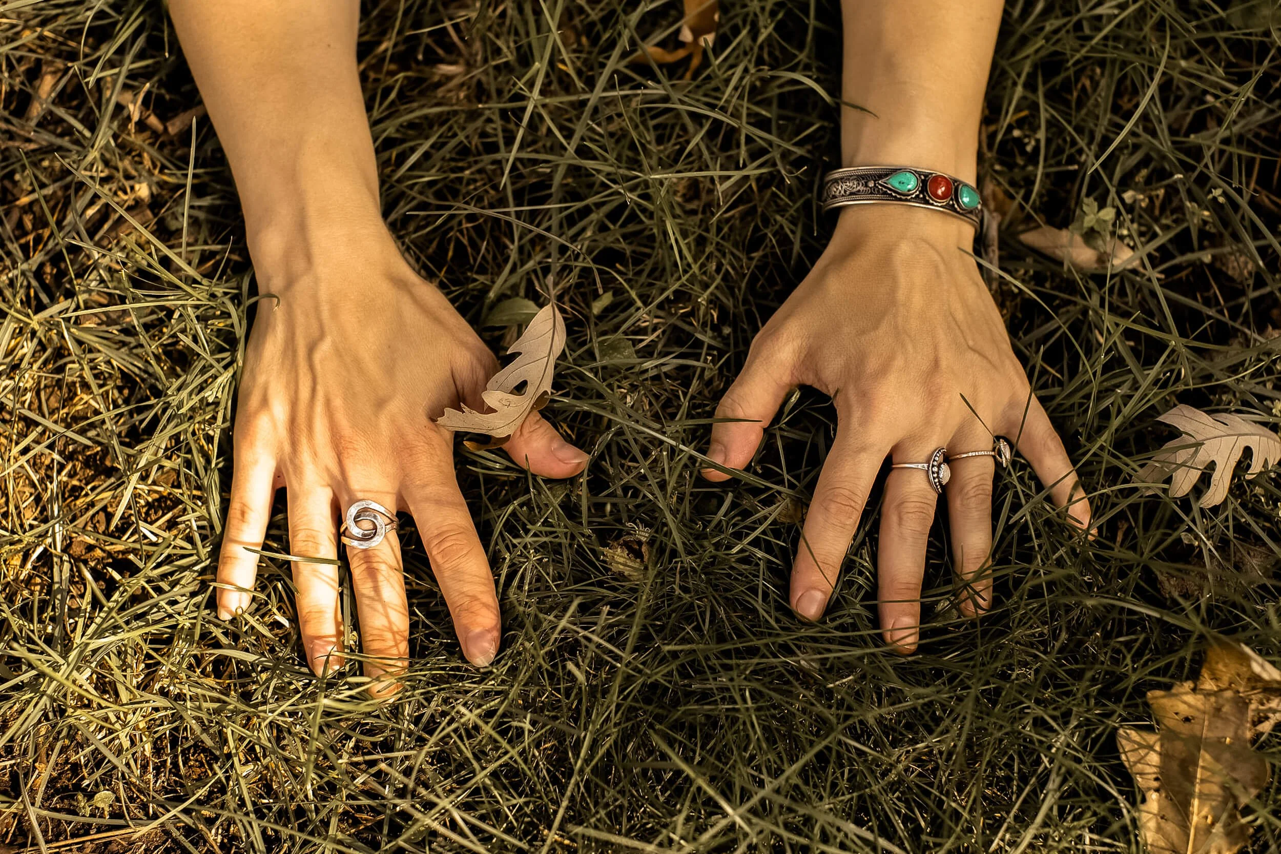 closeup of Kristi's hands while kowtowing to the earth