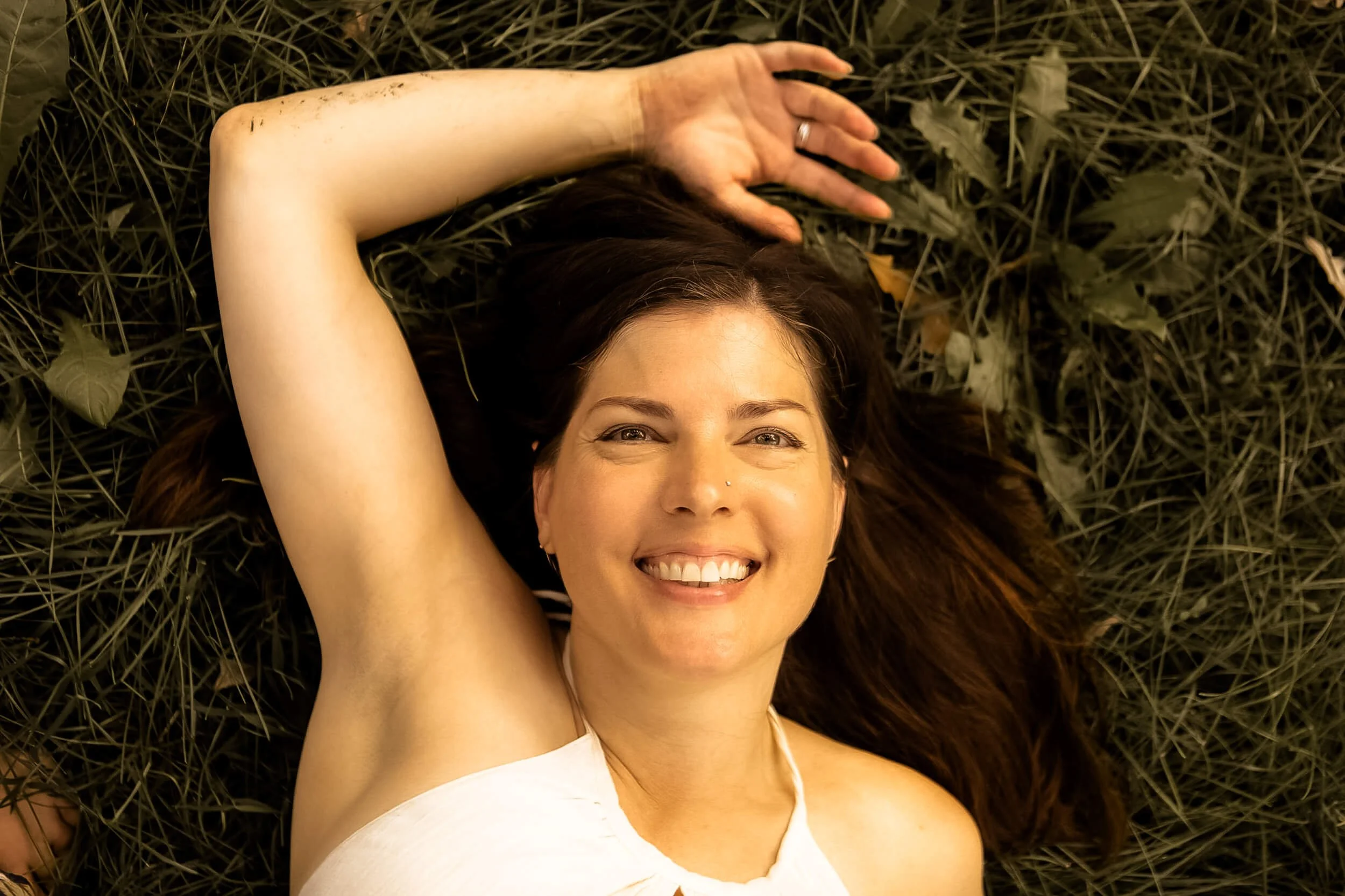 Kristi lying down in the grass
