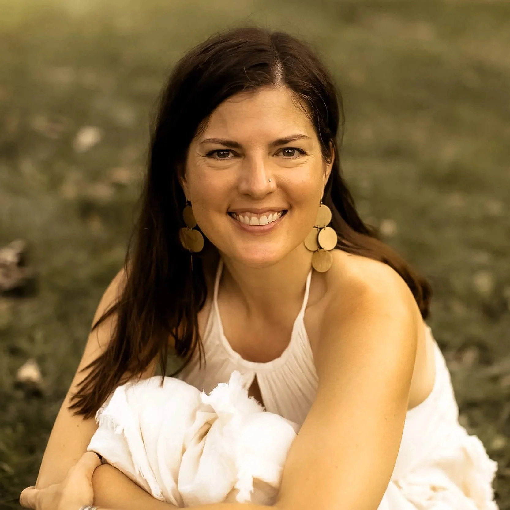 Kristi sitting in the grass