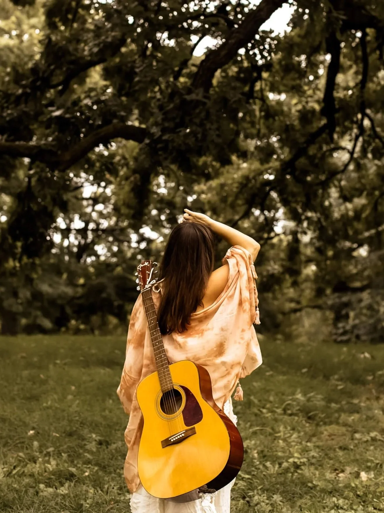 Kristi walking away with her guitar on her back and her hand up to her head...like a "whoa is me" vibe
