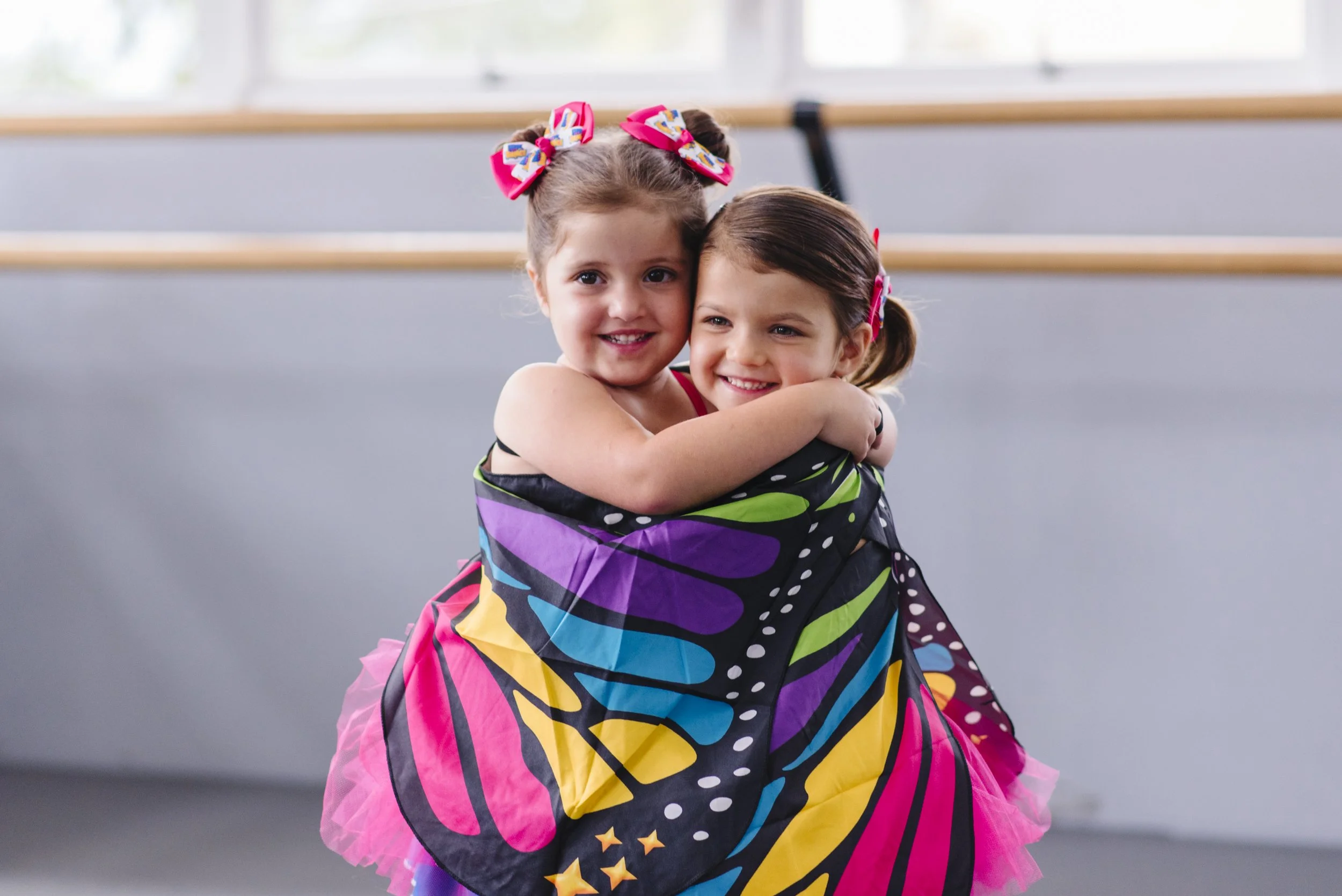 Toddler girls with butterfly wings in a Ready Set Ballet class.