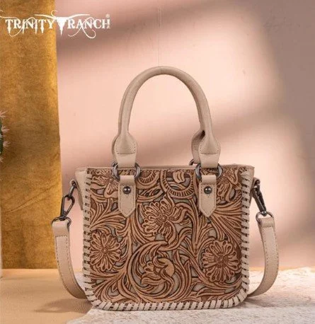 Trinity Ranch embroidered handbag with floral and swirl patterns, beige handles, and an adjustable shoulder strap.