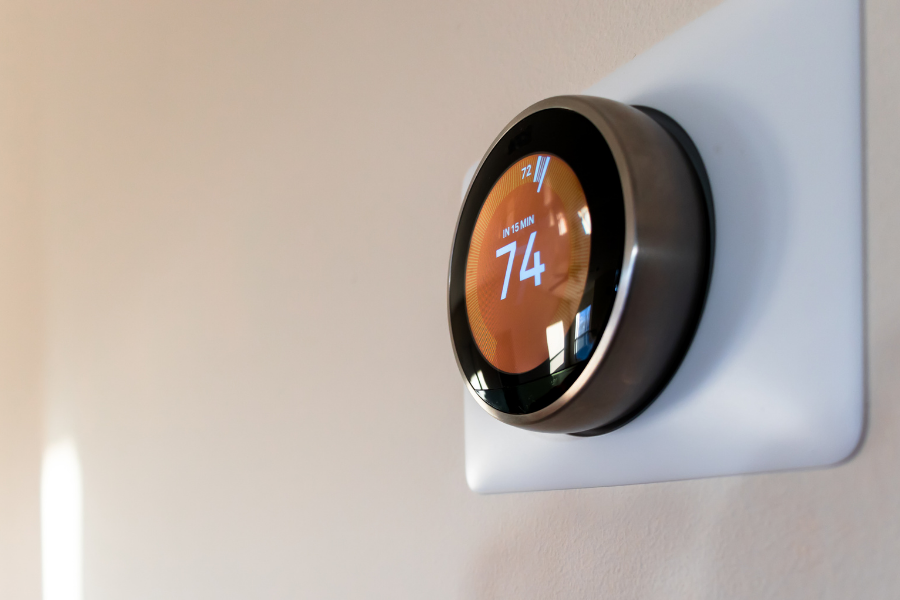Digital thermostat displaying a temperature of 74°F with a reading of 15 minutes for a scheduled change.