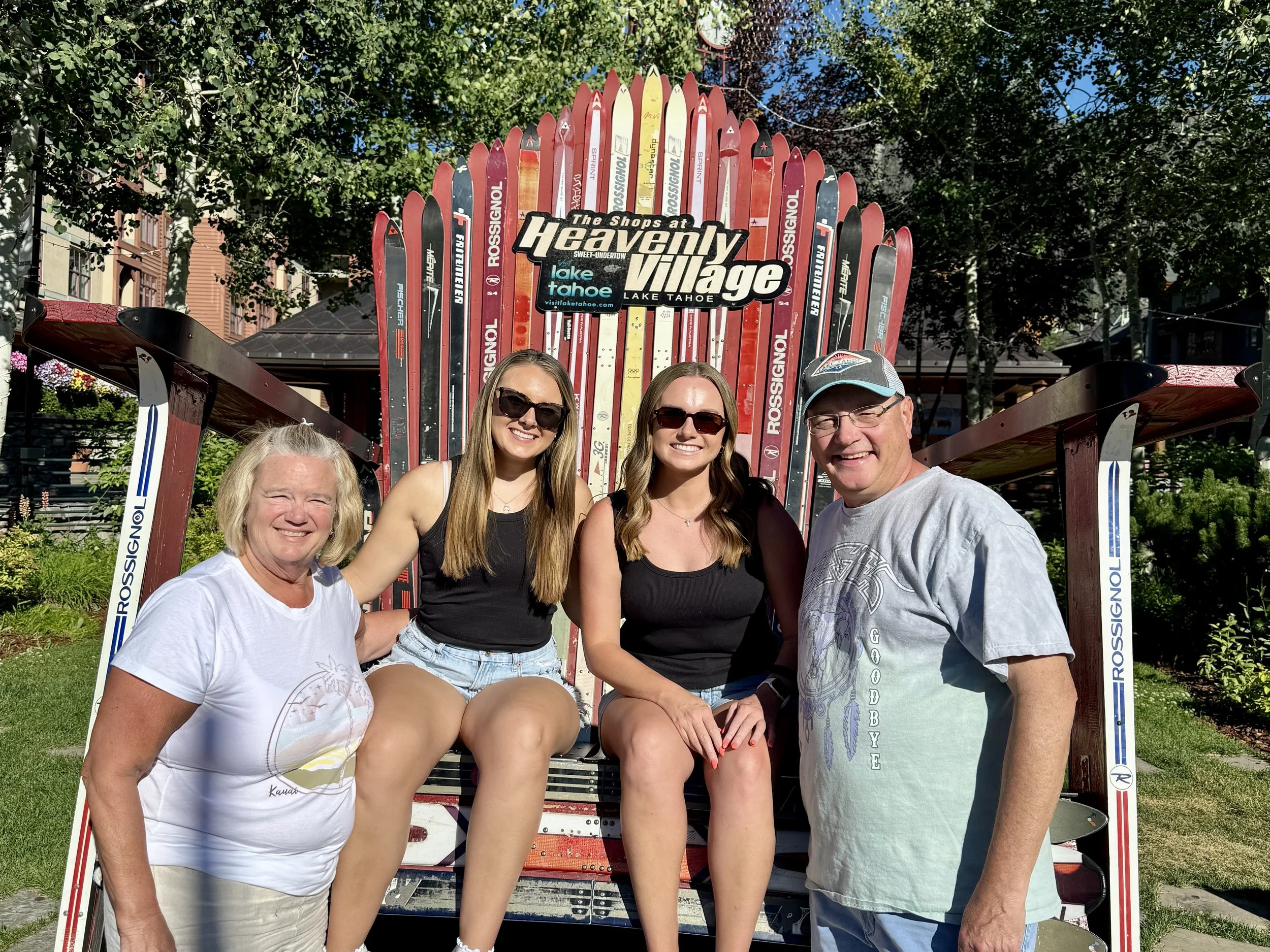 Guests posing during a Taste of Tahoe Tours chef-led food tour in South Lake Tahoe, California, with Heavenly Village and the Sierra Nevada in the background.