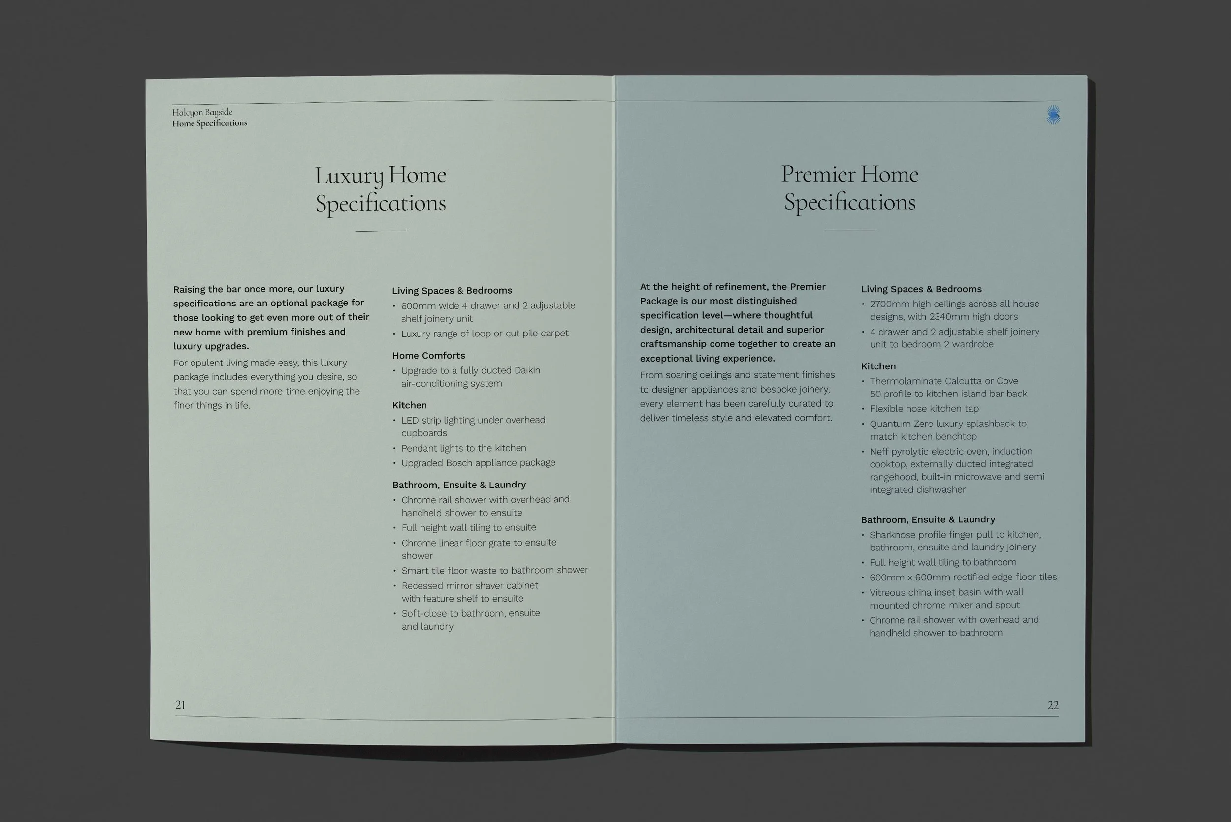Open magazine or brochure displaying home specifications for luxury and premier homes, including details on living spaces, bedrooms, kitchens, bathrooms, and laundry features.