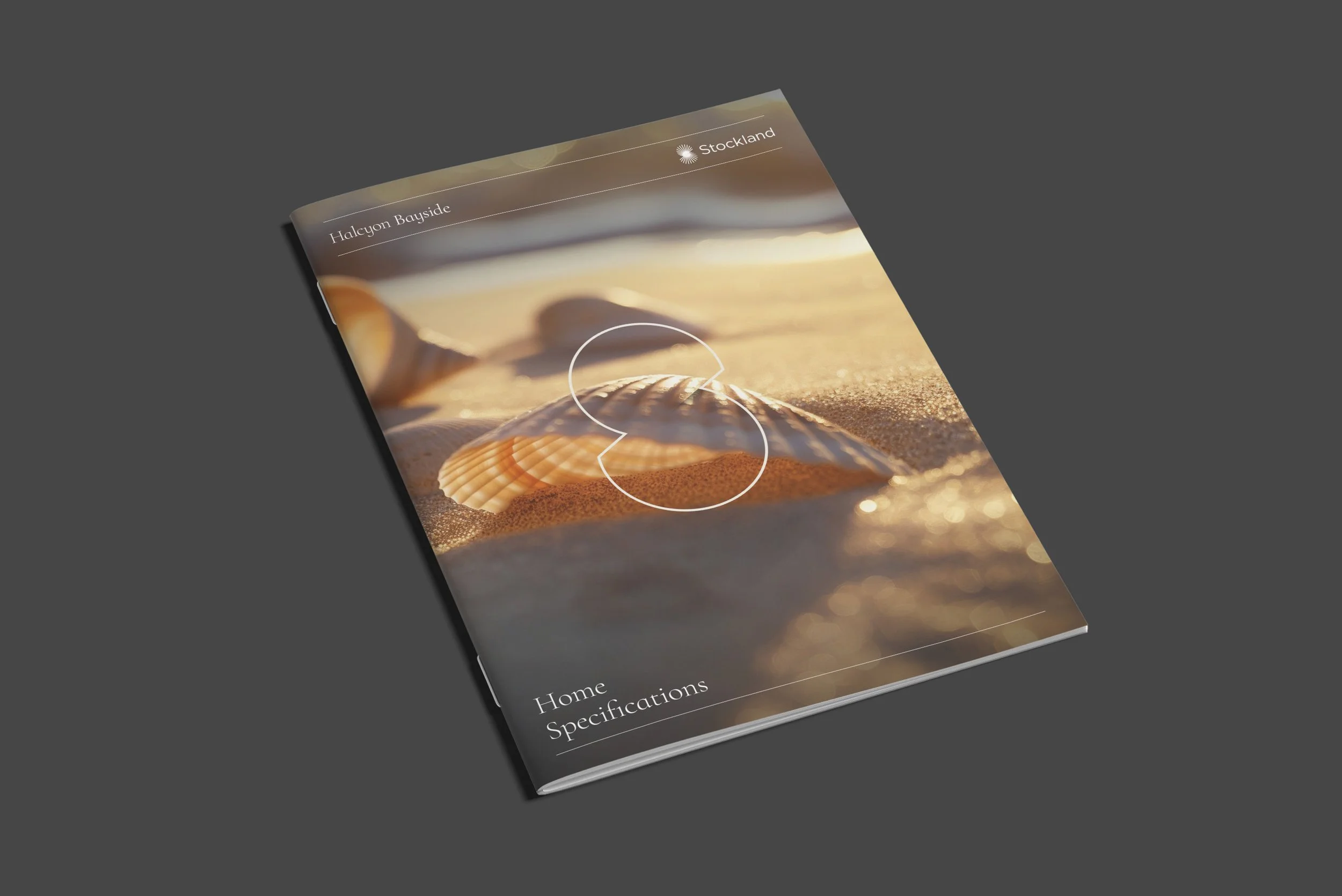 Brochure cover with a beach scene, seashells, and text reading 'Halcyon Bayside' and 'Stockland'.