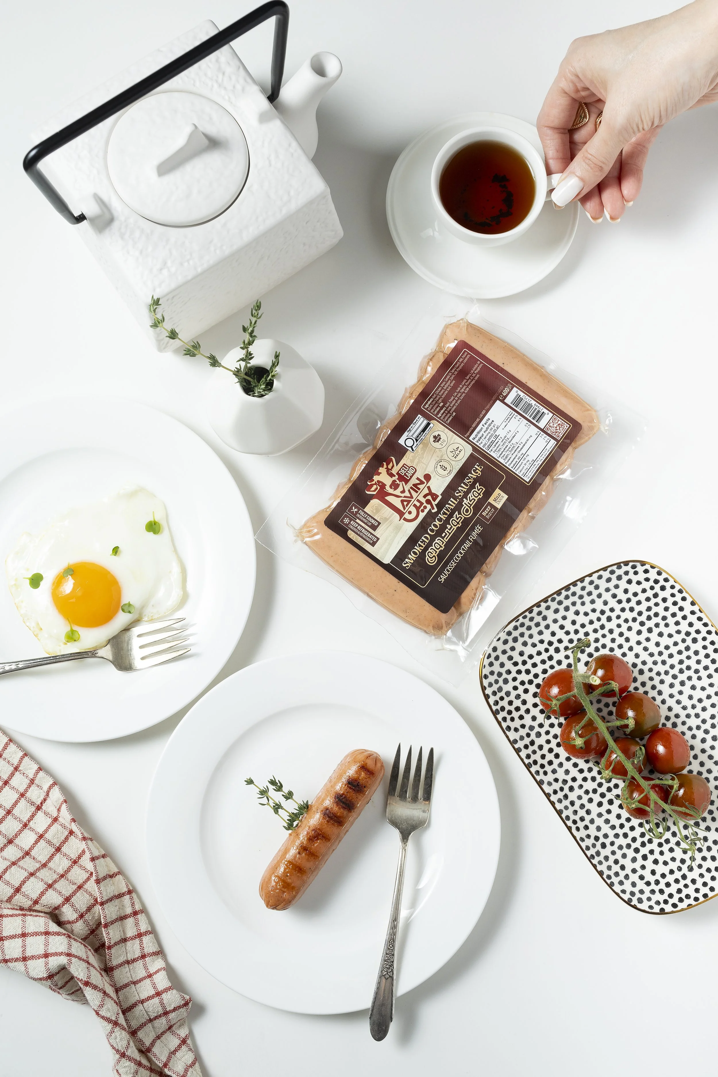 Overhead commercial food photography of a styled breakfast scene with packaged food product and table setting.