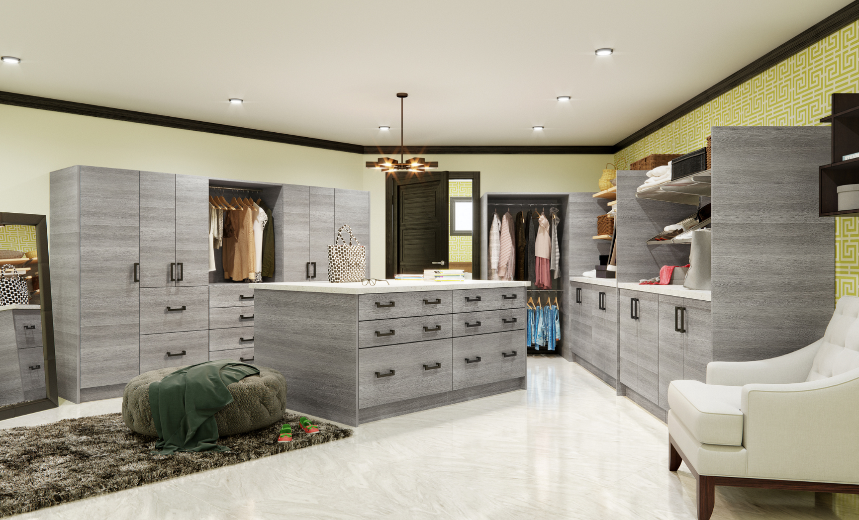 A spacious walk-in closet with multiple gray cabinets and open shelving filled with clothes and accessories. There is a lounging chair in the corner, a mirror, and a small ottoman with clothes on it. The room has a light-colored floor, a partially op